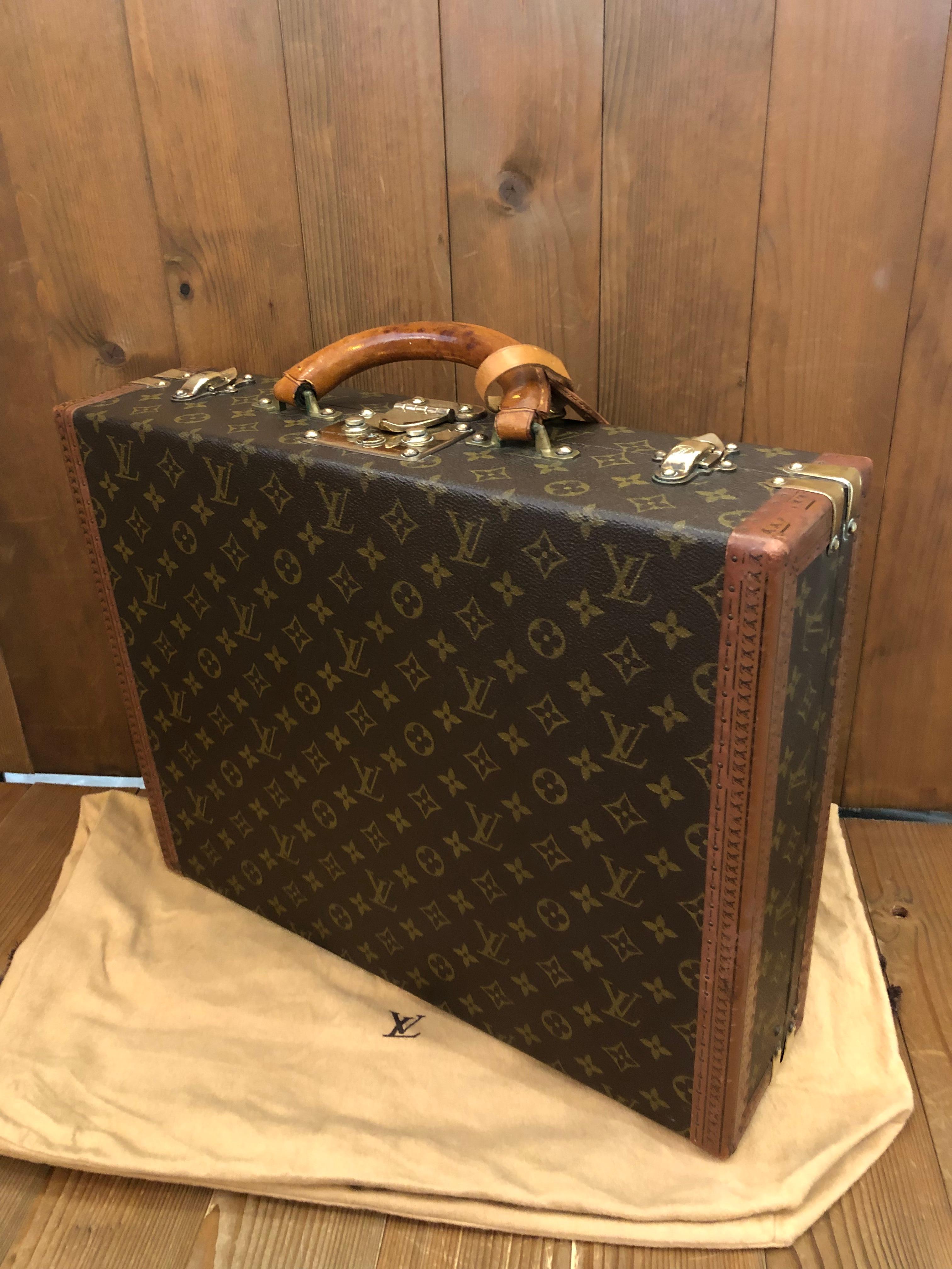 This vintage LOUIS VUITTON Cotteville 45 trunk case is crafted of LV’s monogram canvas and vachetta leather. Made in France with serial no 988184. Measures approximately 17.5 x 13.5 x 4.25 inches. Comes with dust bag from another LV and luggage