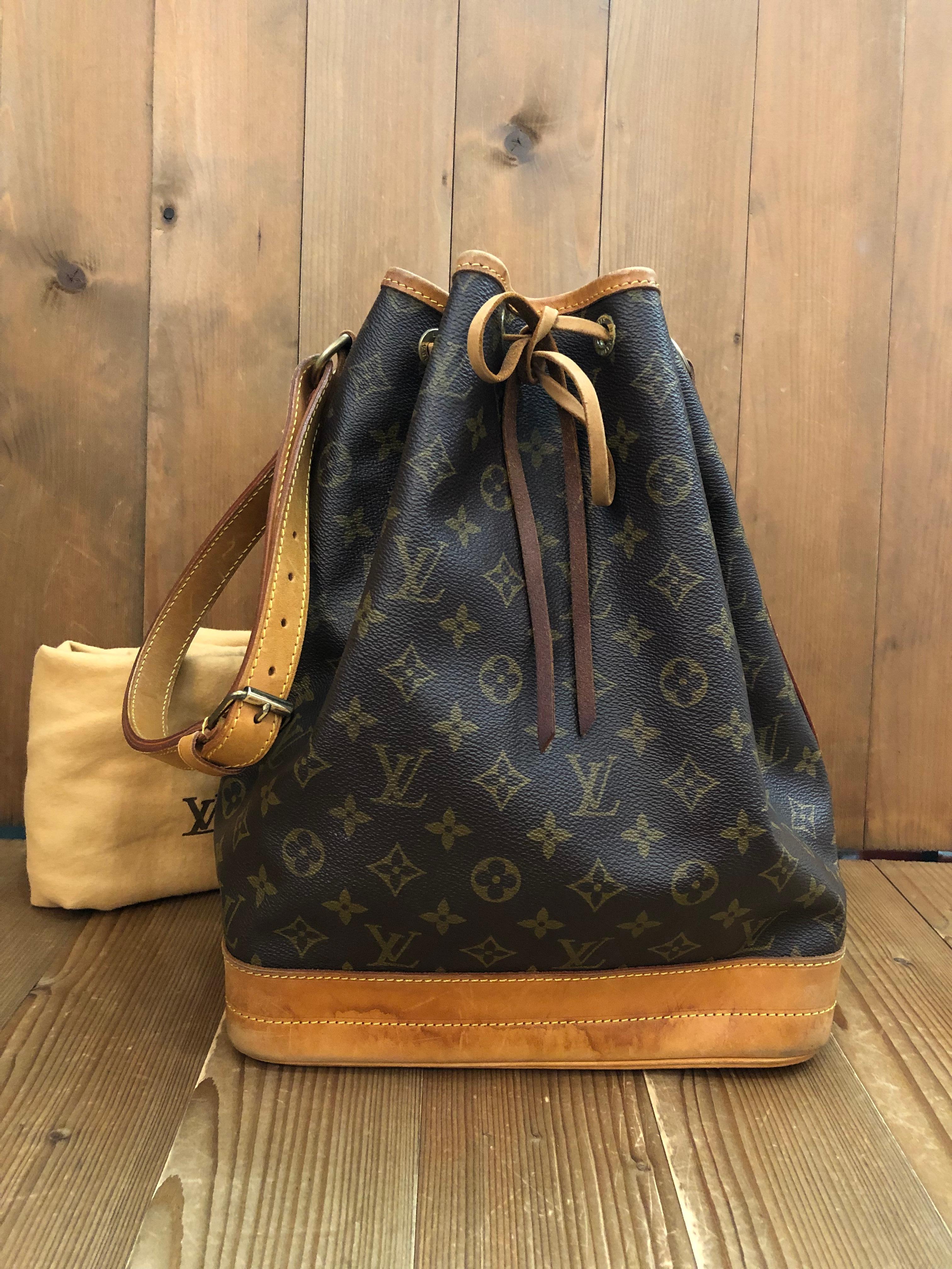 This vintage LOUIS VUITTON Noe GM shoulder bag is crafted of Louis Vuitton’s monogram canvas and vachetta leather. 
Noe was originally created in 1932 to carry bottles of Champagne. Made in France with date-code A2 8905. Measures 10.5 x 13.75 x 7.5