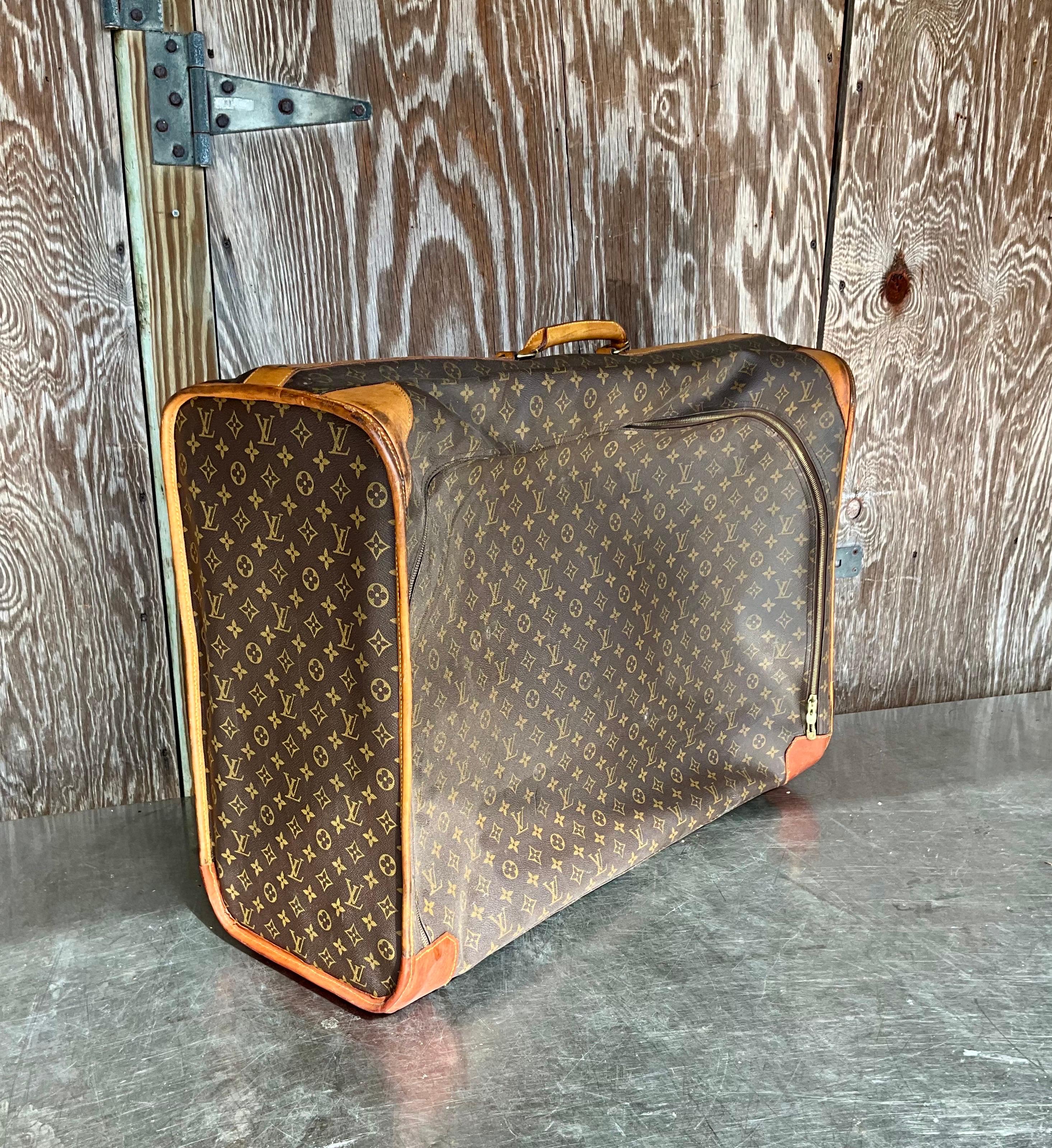 This Vintage Louis Vuitton Monogram Pullman Suitcase is more than just a functional travel accessory; it is a statement of luxury, style, and prestige. The iconic monogram canvas, combined with high-quality craftsmanship and durable materials, makes