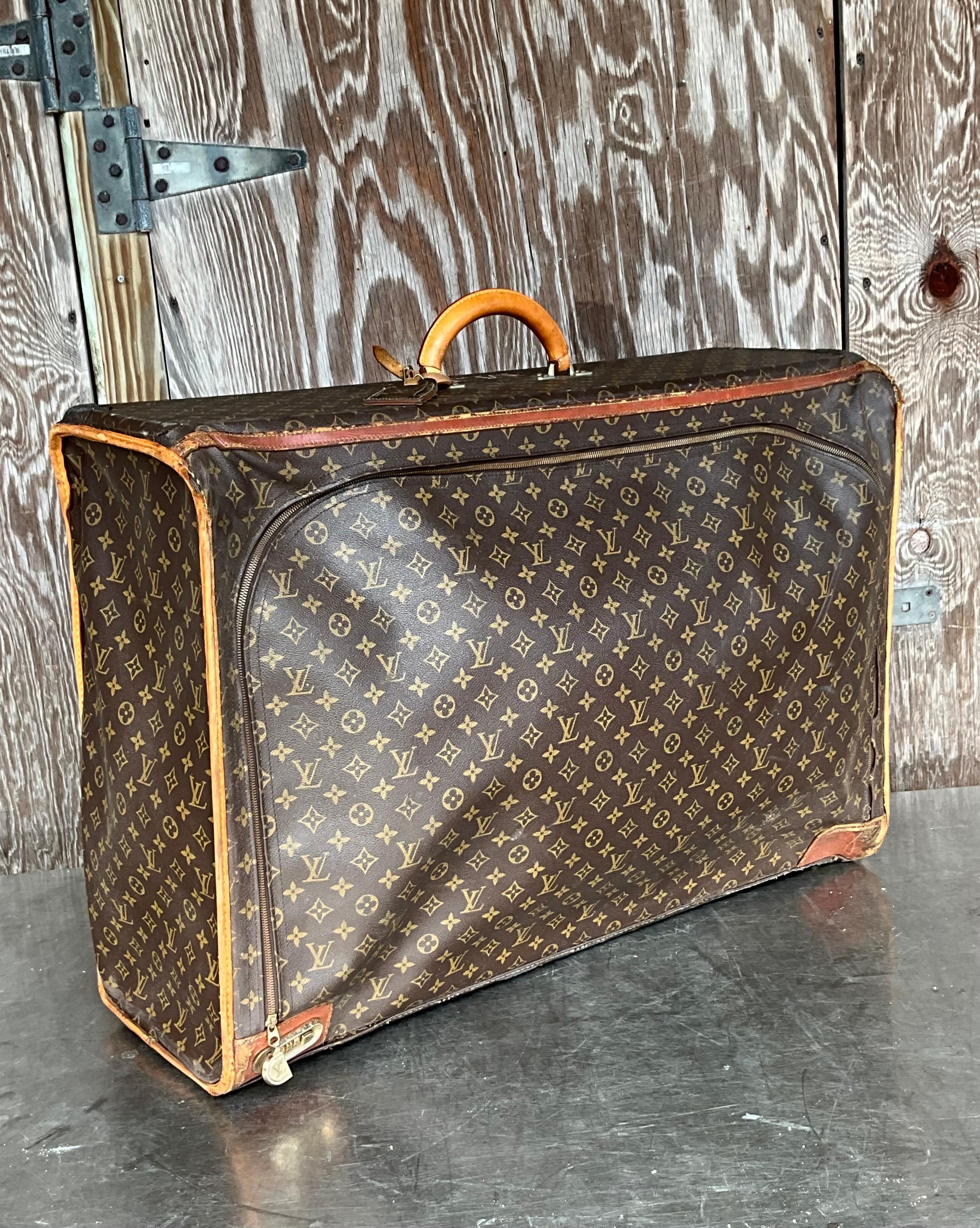 This Vintage Louis Vuitton Monogram Pullman Suitcase is more than just a functional travel accessory; it is a statement of luxury, style, and prestige. The iconic monogram canvas, combined with high-quality craftsmanship and durable materials, makes
