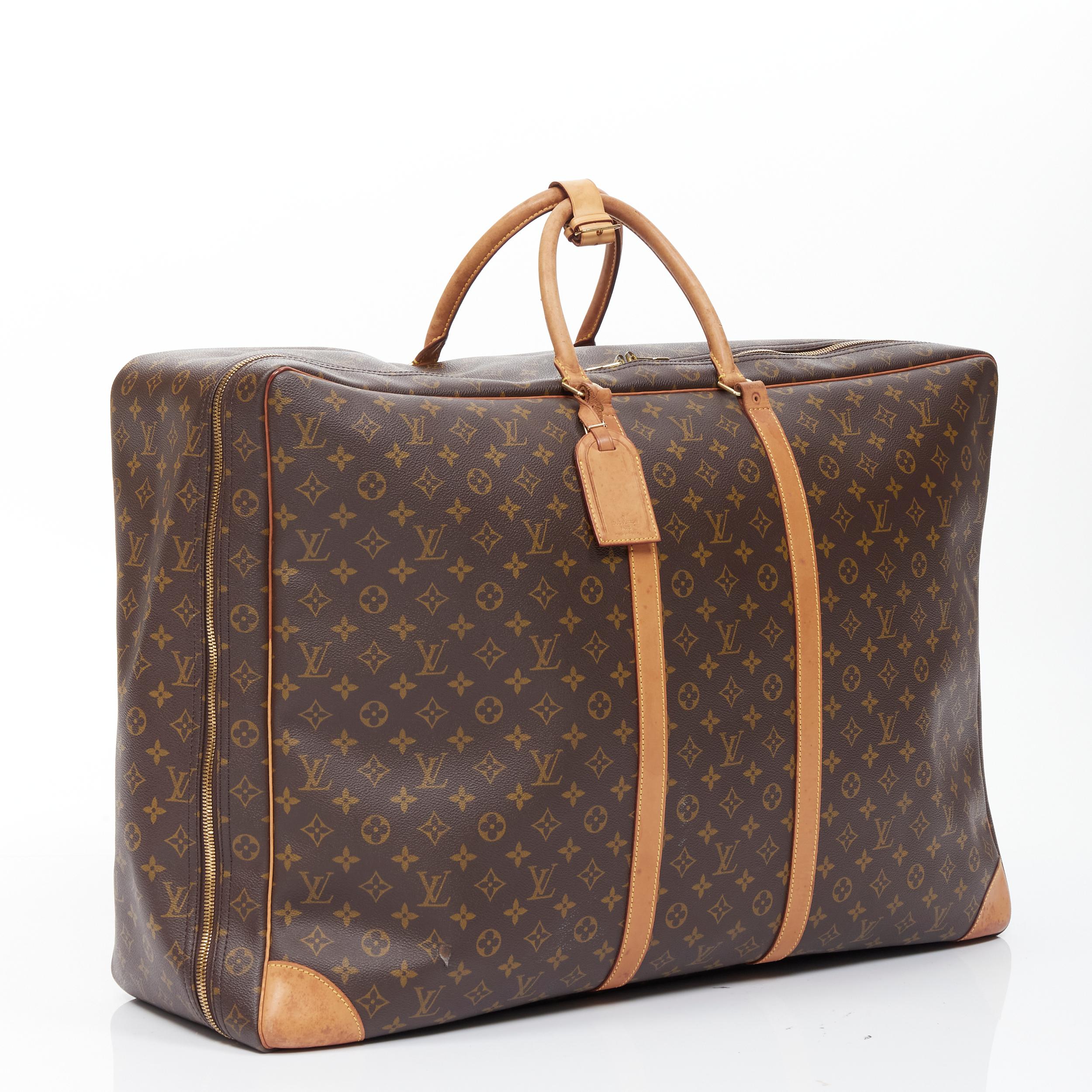 vintage LOUIS VUITTON Monogram Sirius 70 coated canvas LV rolled handle luggage 
Reference: GIYG/A00101 
Brand: Louis Vuitton 
Model: Sirius 70 
Material: Canvas 
Color: Brown 
Pattern: Solid 
Closure: Zip Extra Detail: Sirius 70. Vintage monogram.