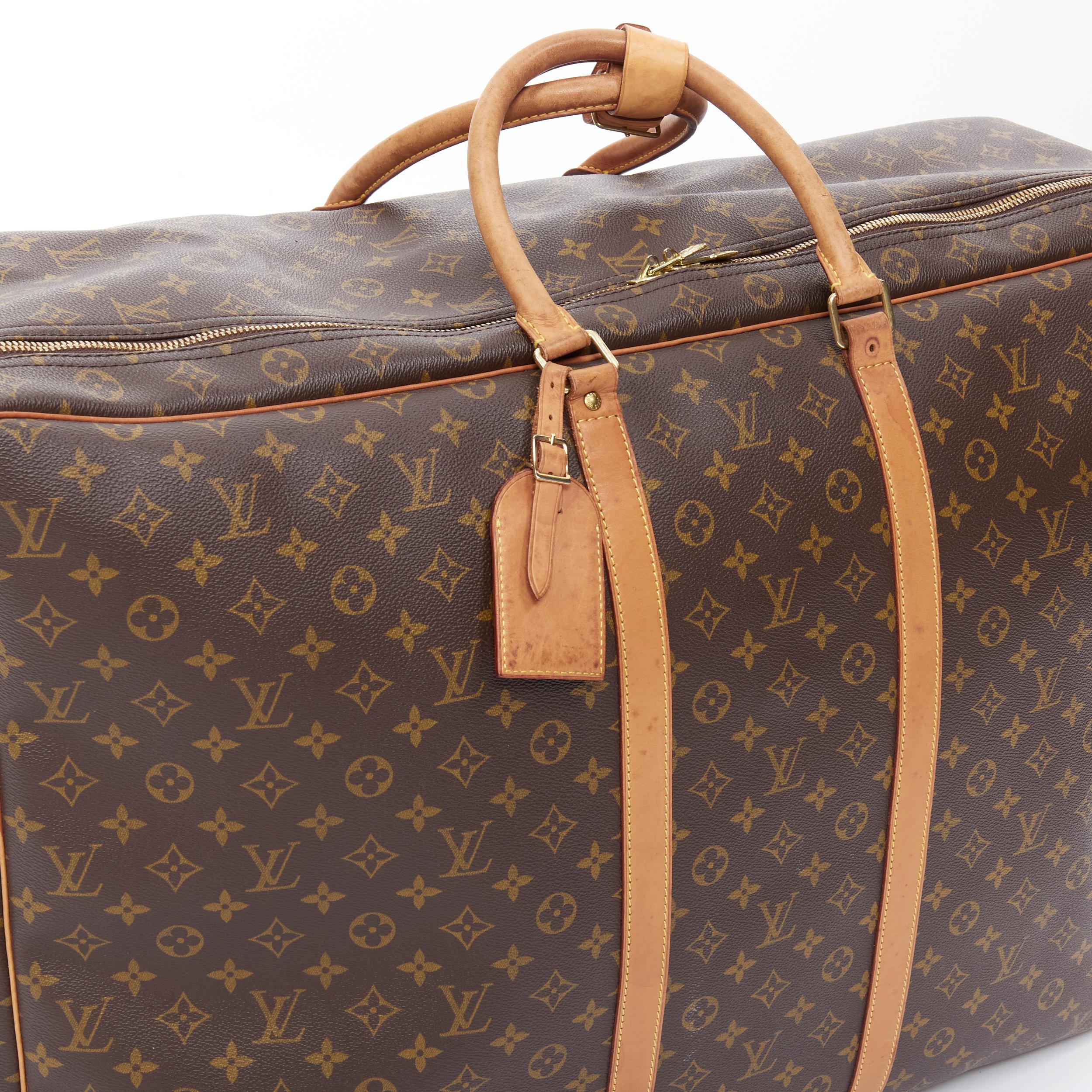 Brown vintage LOUIS VUITTON Monogram Sirius 70 coated canvas LV rolled handle luggage