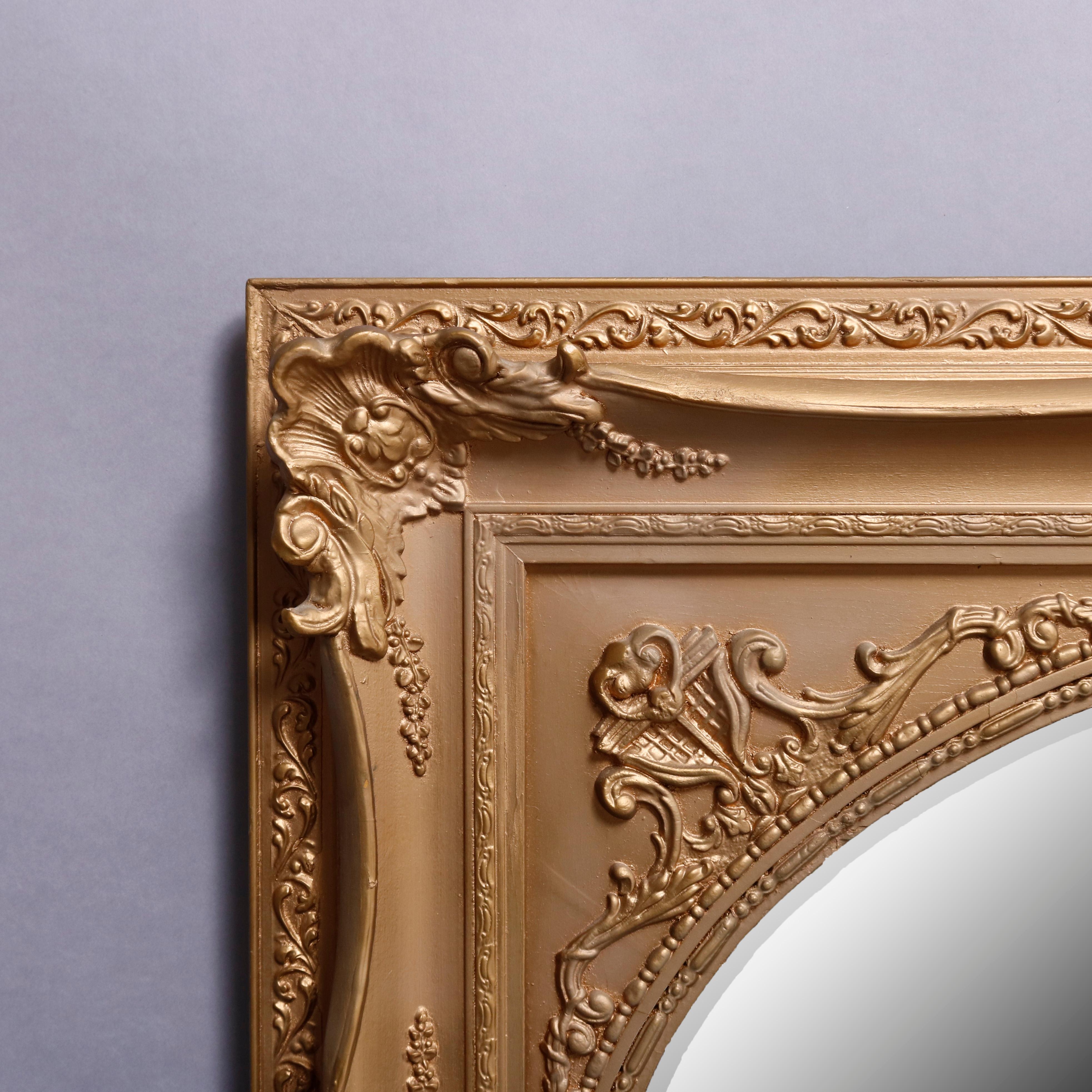 A vintage Louis XIV style giltwood wall mirror offers rectangular foliate and scroll decorated surround and oval beveled mirror, en verso original label, 20th century

Measures: 32.5