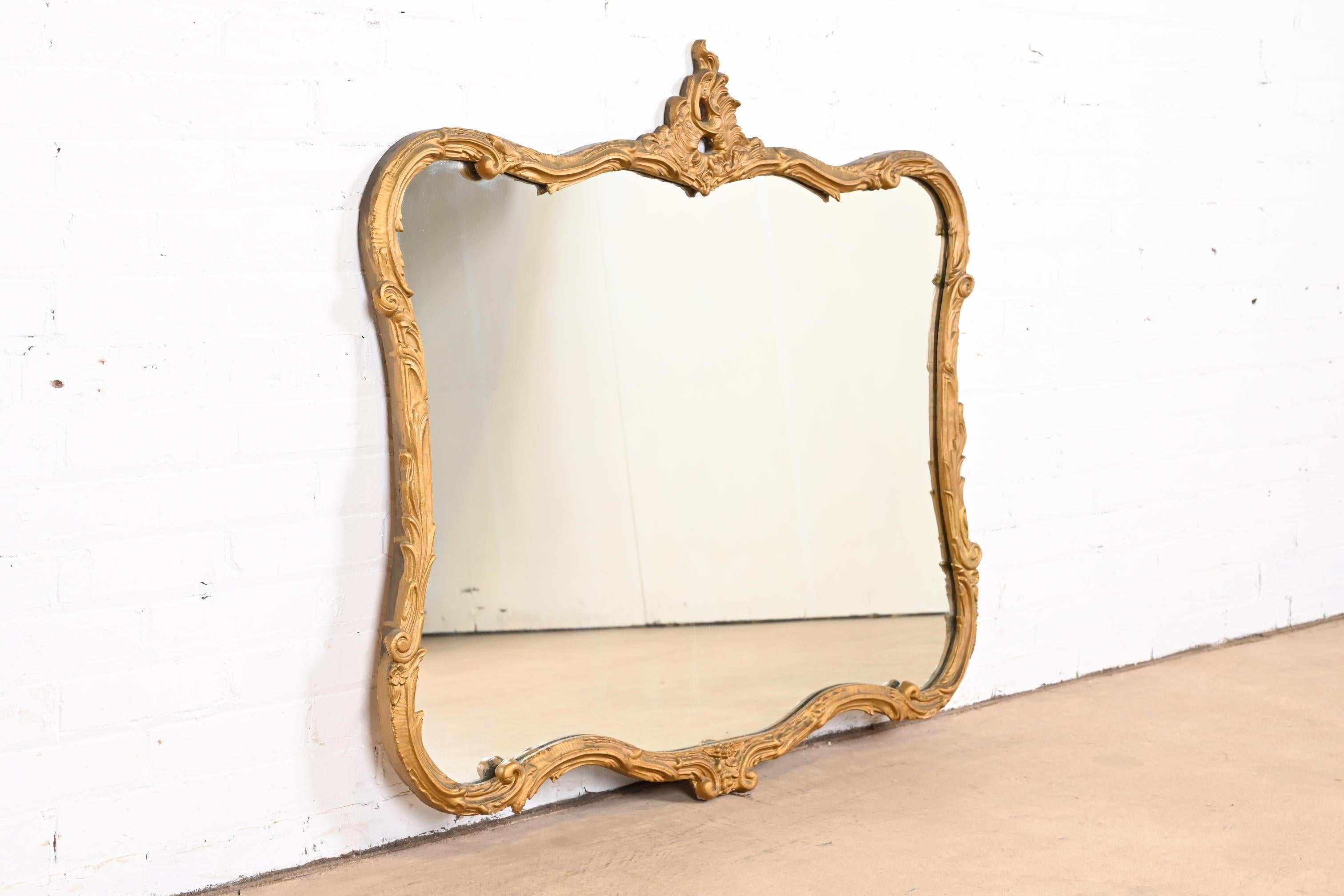 A gorgeous vintage Louis XV French Rococo style carved giltwood framed wall mirror

Early 20th Century

Measures: 42