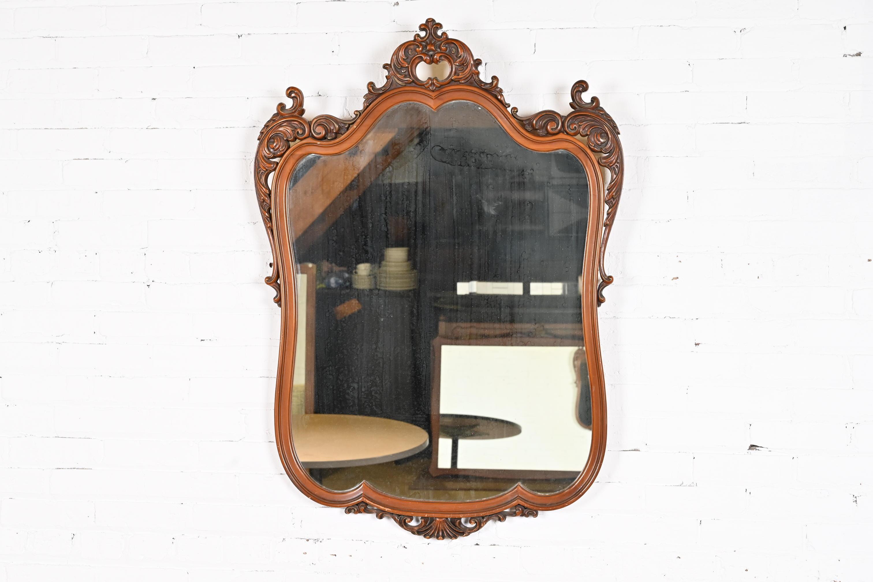A beautiful vintage Louis XV French Rococo or Baroque style carved walnut framed wall mirror

In the manner of Romweber

USA, Circa 1940s

Measures: 31