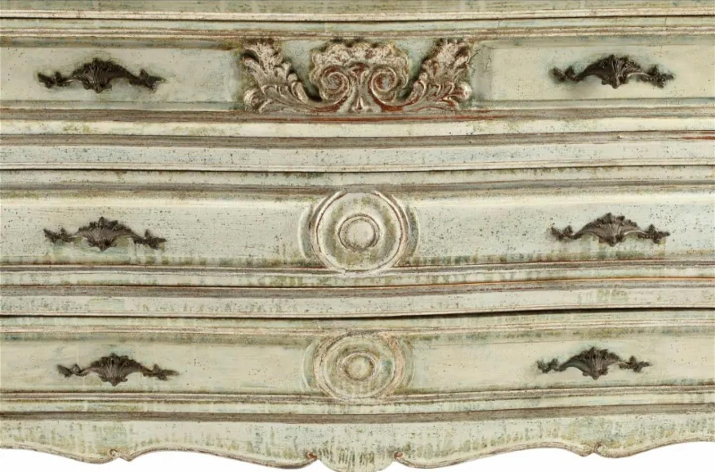A shabby chic vintage country French Provincial Louis XV style distressed painted bombe chest of drawers commode, 20th century, having a serpentine shaped faux marble top, curvacious solid wood case, fitted with three drawers affixed with patinated