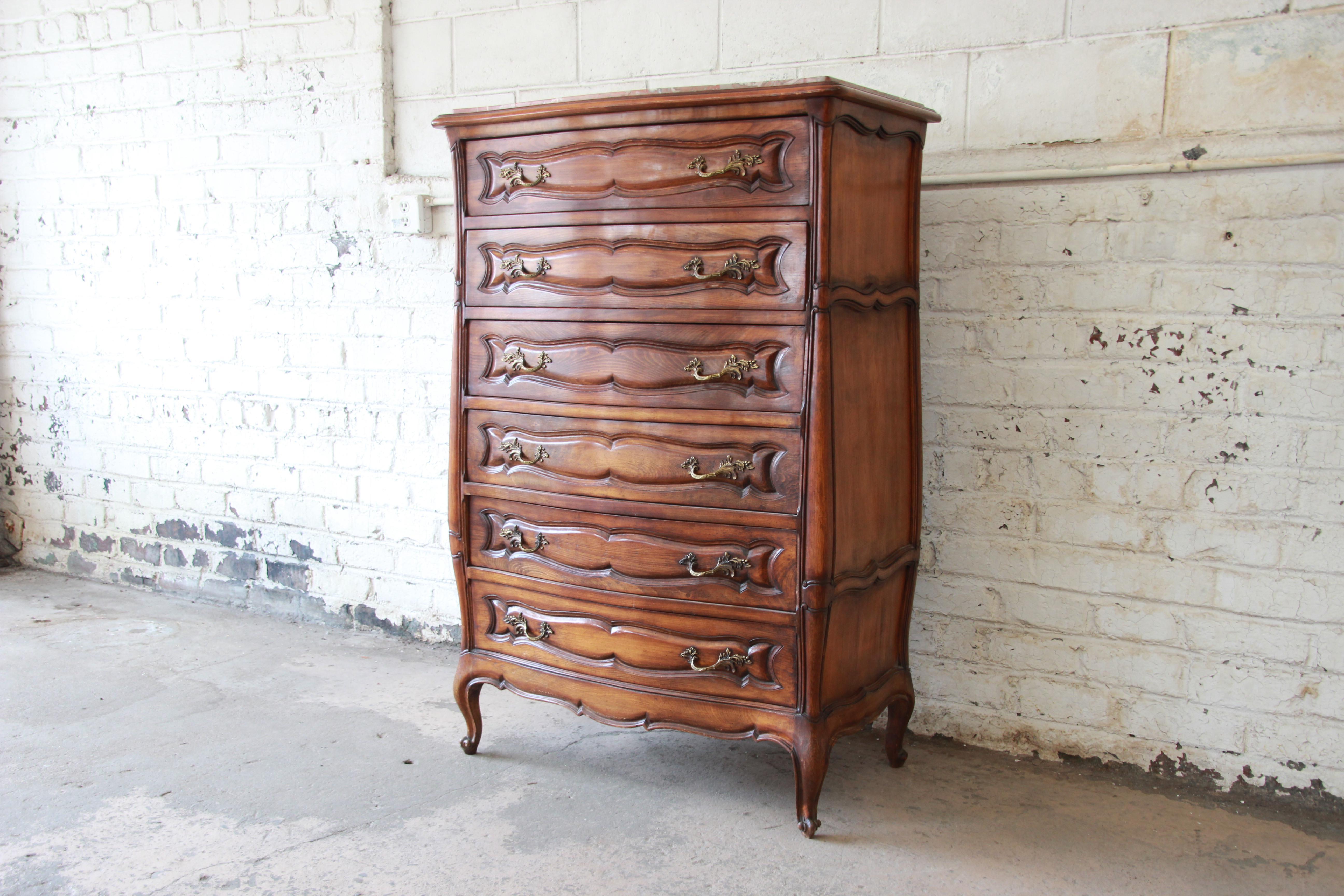 Offering a beautiful vintage Louis XV style marble top highboy dresser from Italy. This substantial French highboy features six drawers for storage and nice pink marble top. The piece is stamped made in Italy and is from the mid-20th century. The
