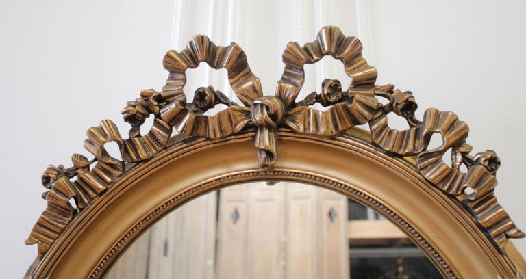 Vintage Louis XV Style Ribbon Carved Oval Giltwood Mirror at 1stDibs