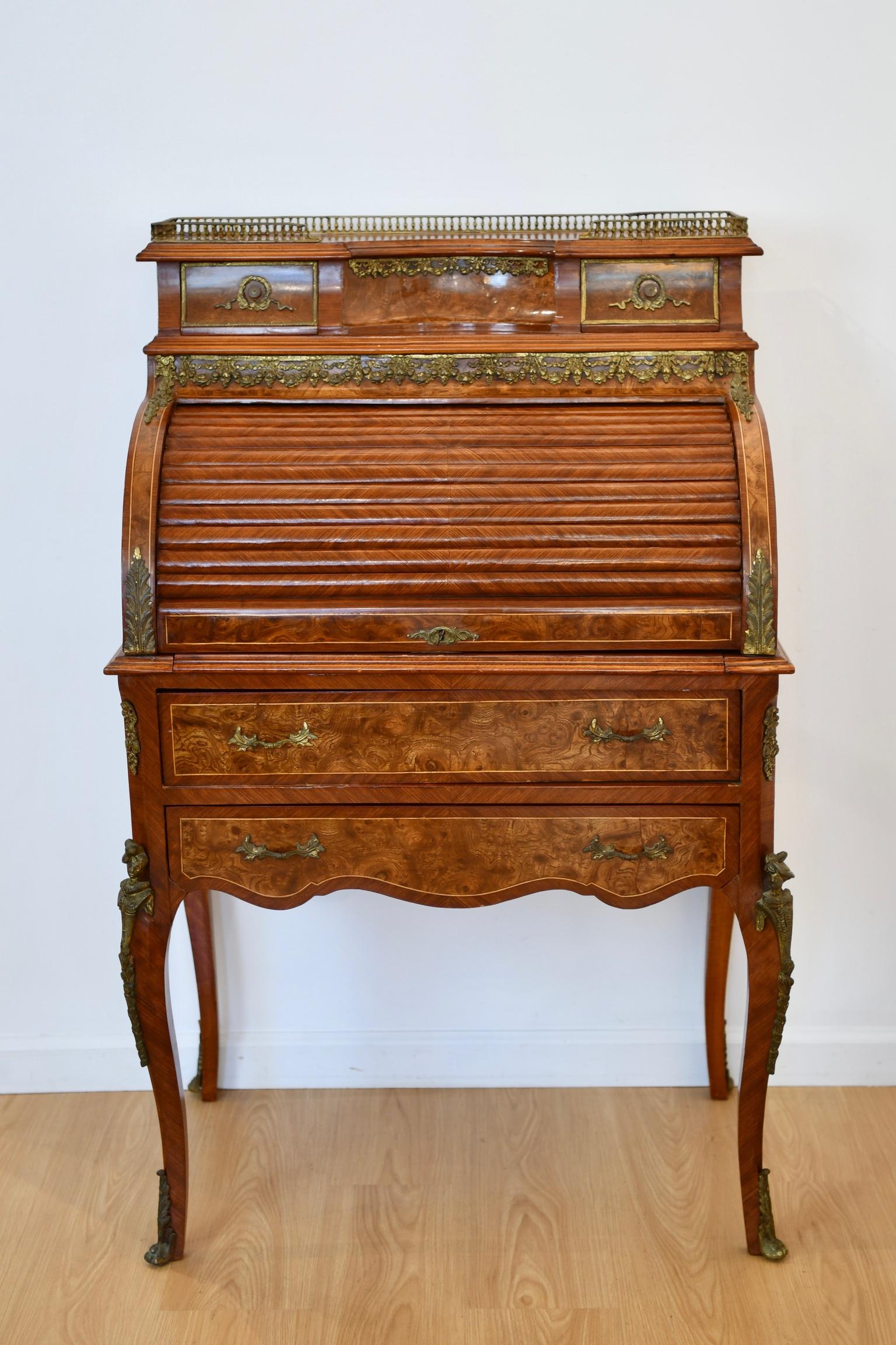 Vintage Louis XV style roll top ladies desk with pull leather writing surface and bronze accents and gallery, circa 20th century. Key included; Missing one drawer. Dimensions: 49