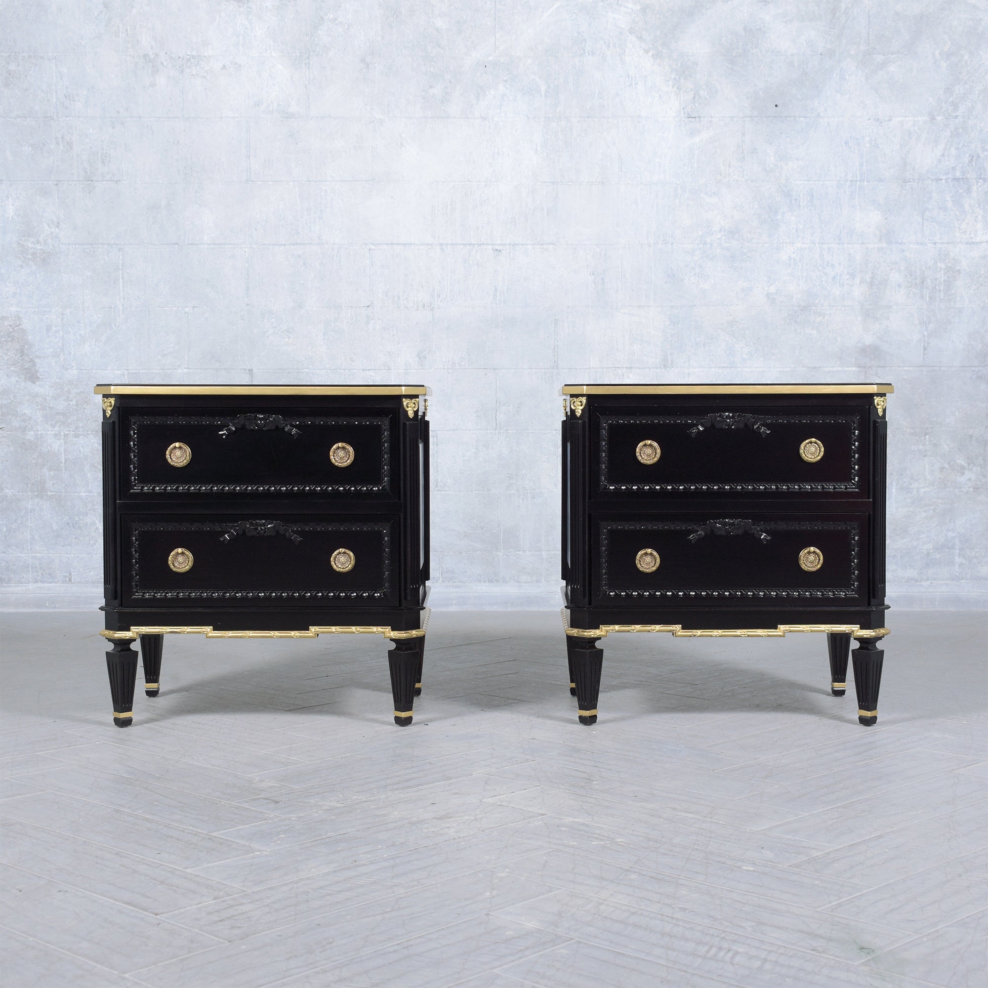 Step into an era of classic elegance with our beautifully restored pair of Louis XVI-style commodes. Crafted with precision from the finest mahogany wood, these vintage nightstands stand out with their ebonized shade, further elevated by tasteful