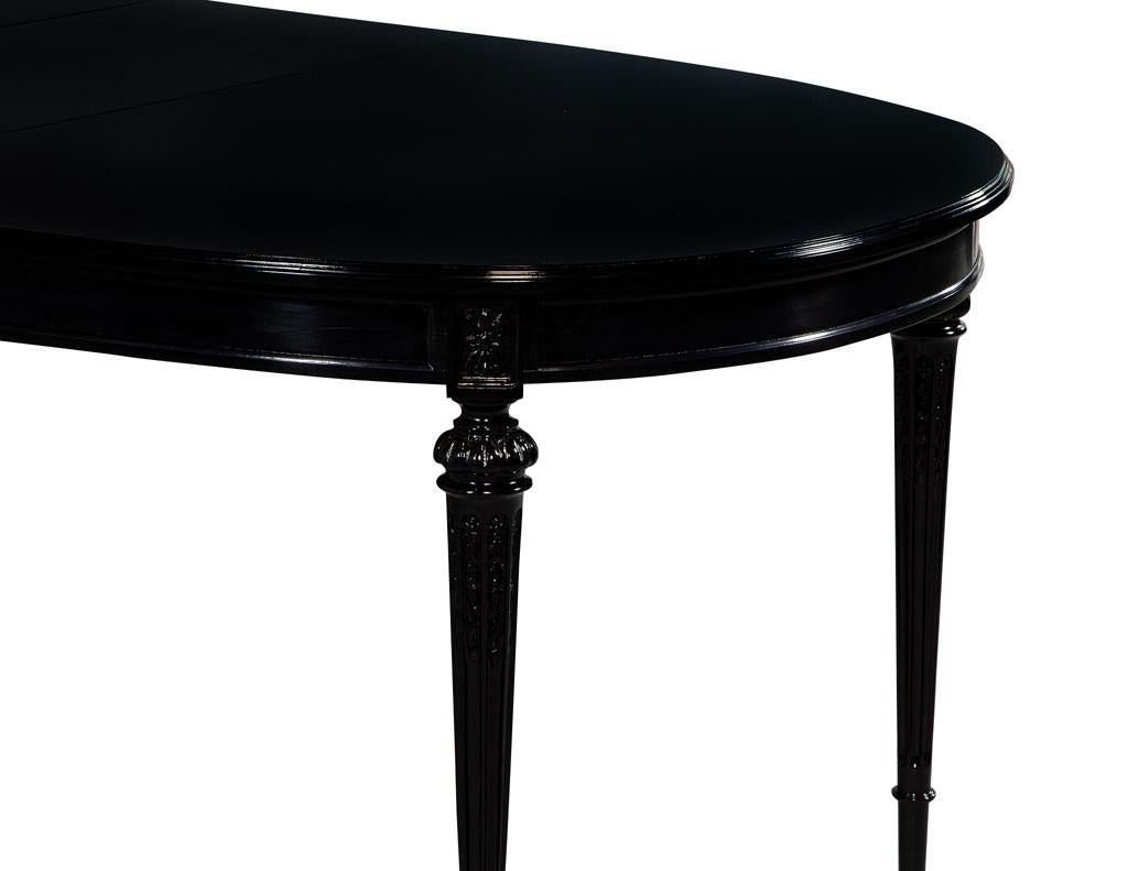 Vintage Louis XVI style black dining table. Fully restored in a rich hand polished black lacquer. This table has an eclectic Classic style that can highlight a modern or traditional setting.

Table fully extends to 100