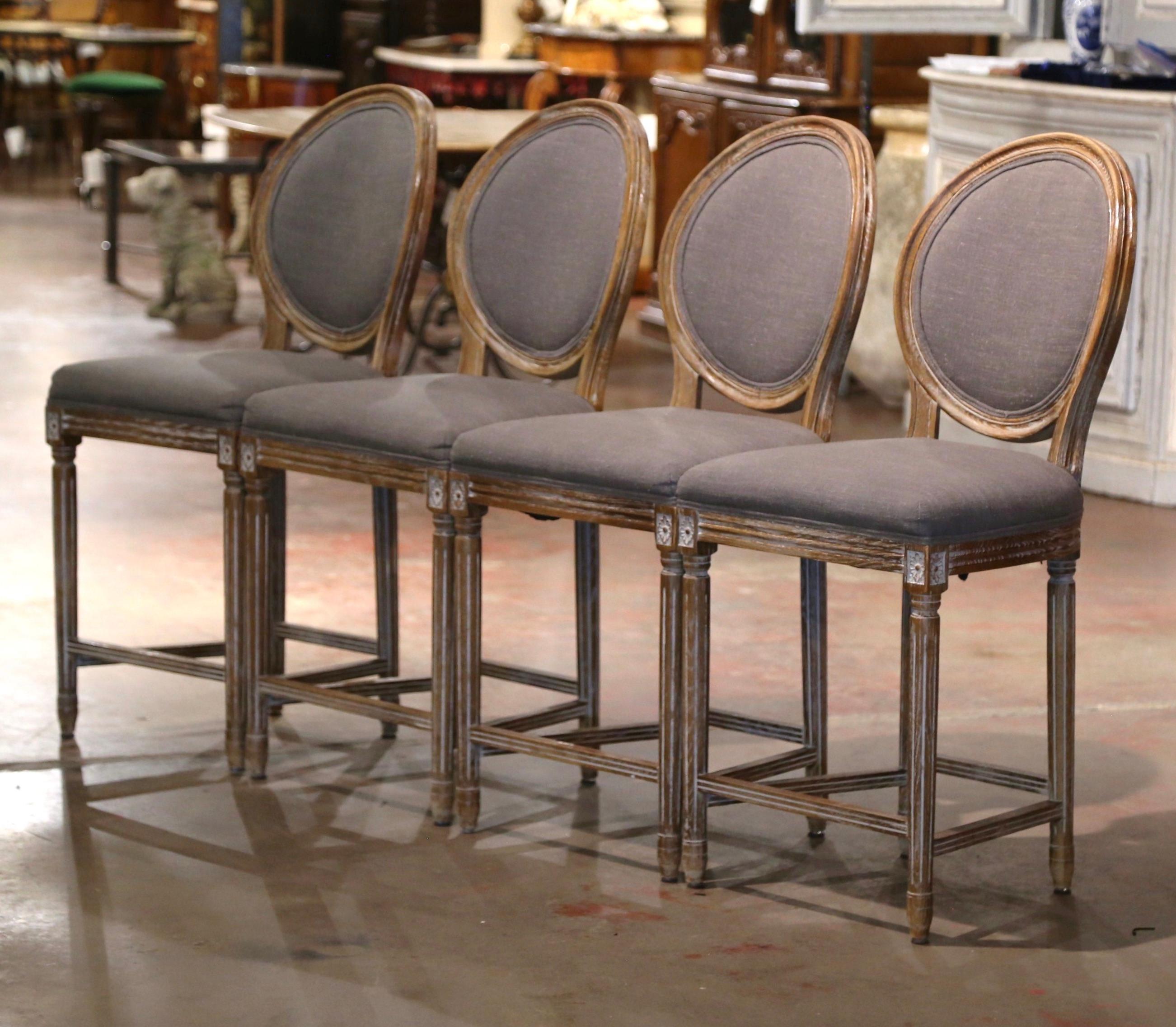 Add a touch of class to your bar or kitchen counter with this elegant suite of four vintage stools. Crafted in France circa 2000, the large classic barstools are the perfect height for a 36 to 38