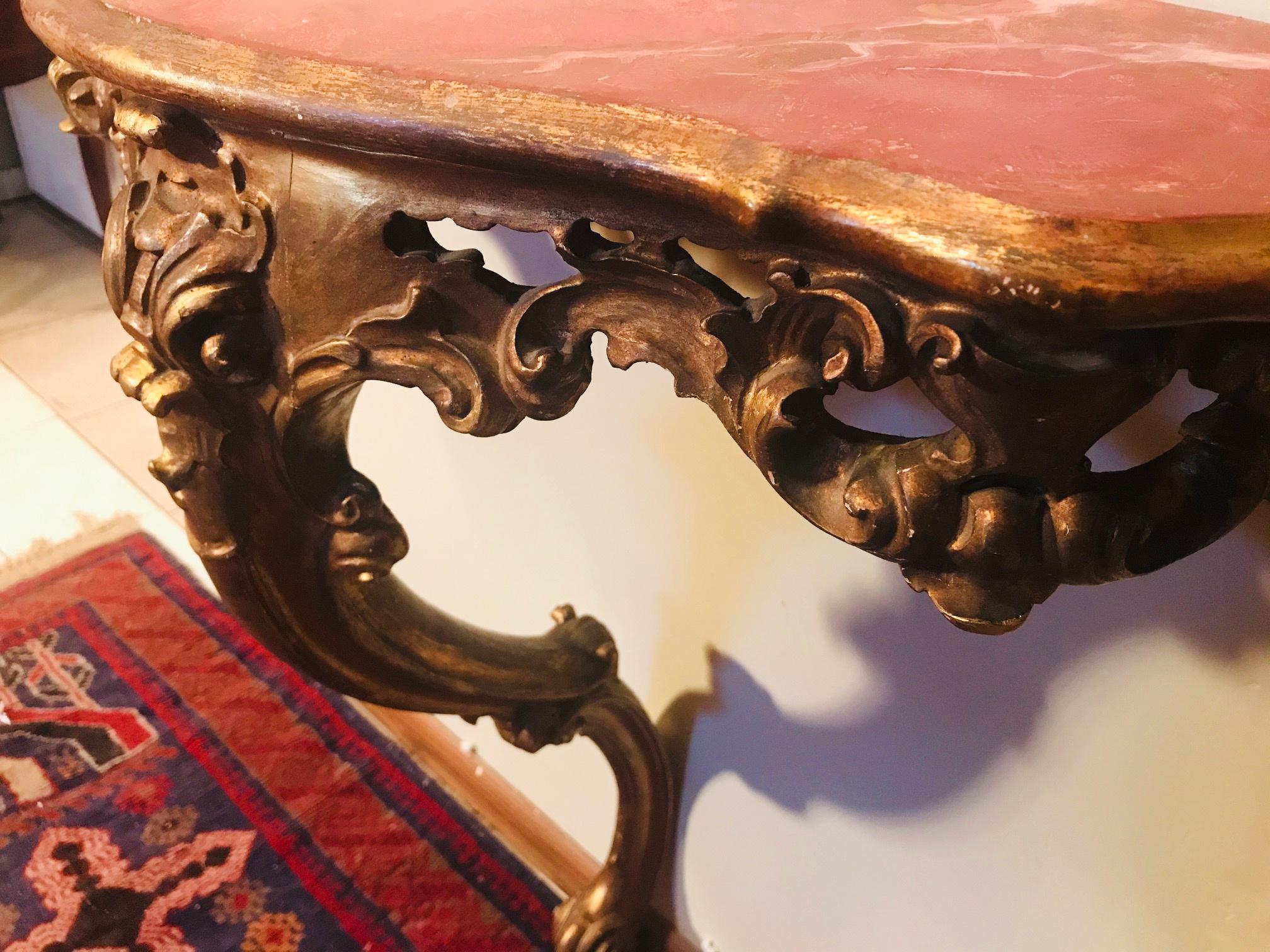Vintage gold leaf French Louis XVI style console table with hand painted faux marble top

This decorative French console table was created circa 1920 in the Louis XVI style. The hand carved work is detailed in a floral and rocaille design. The