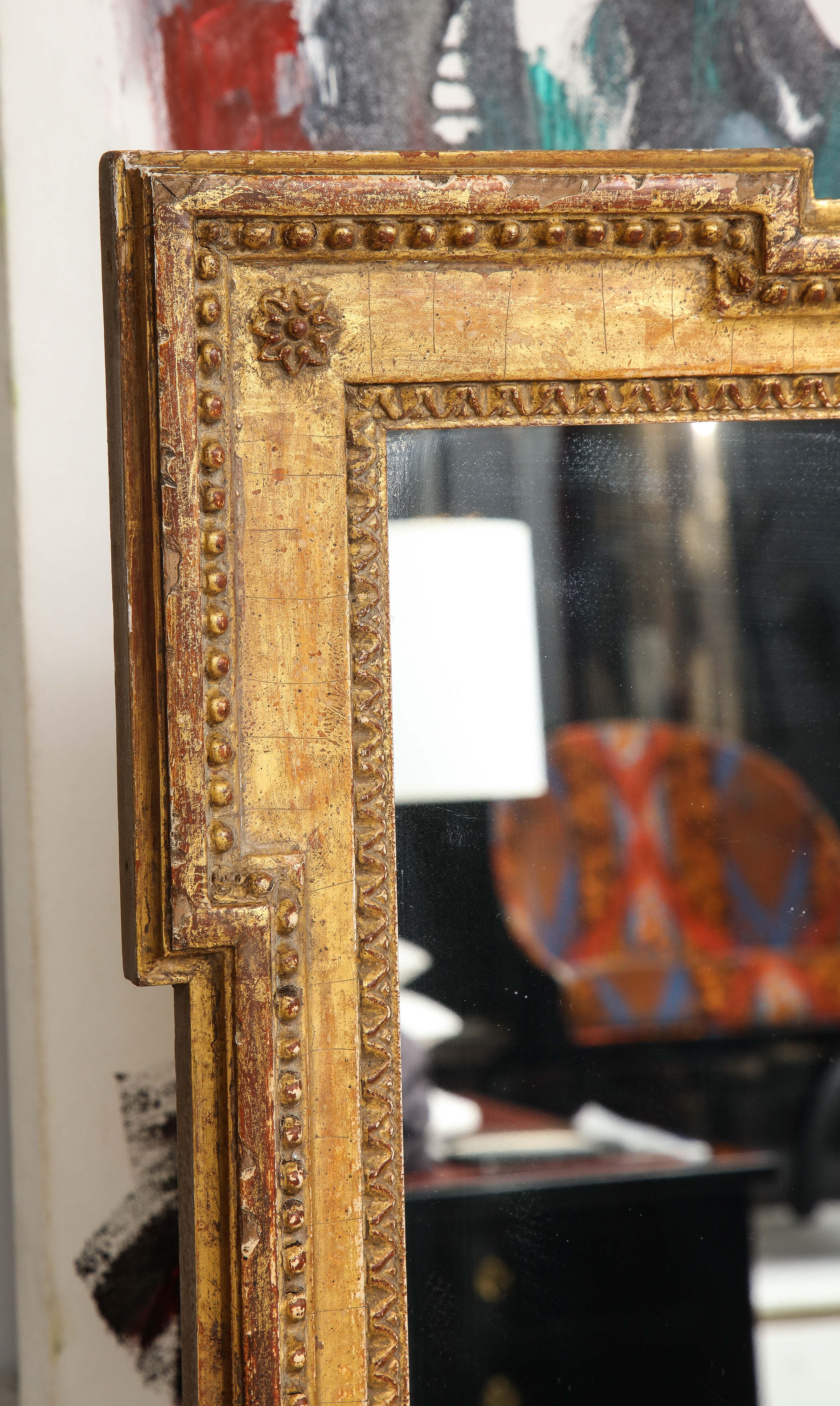 A vintage Louis XVI style giltwood mirror.