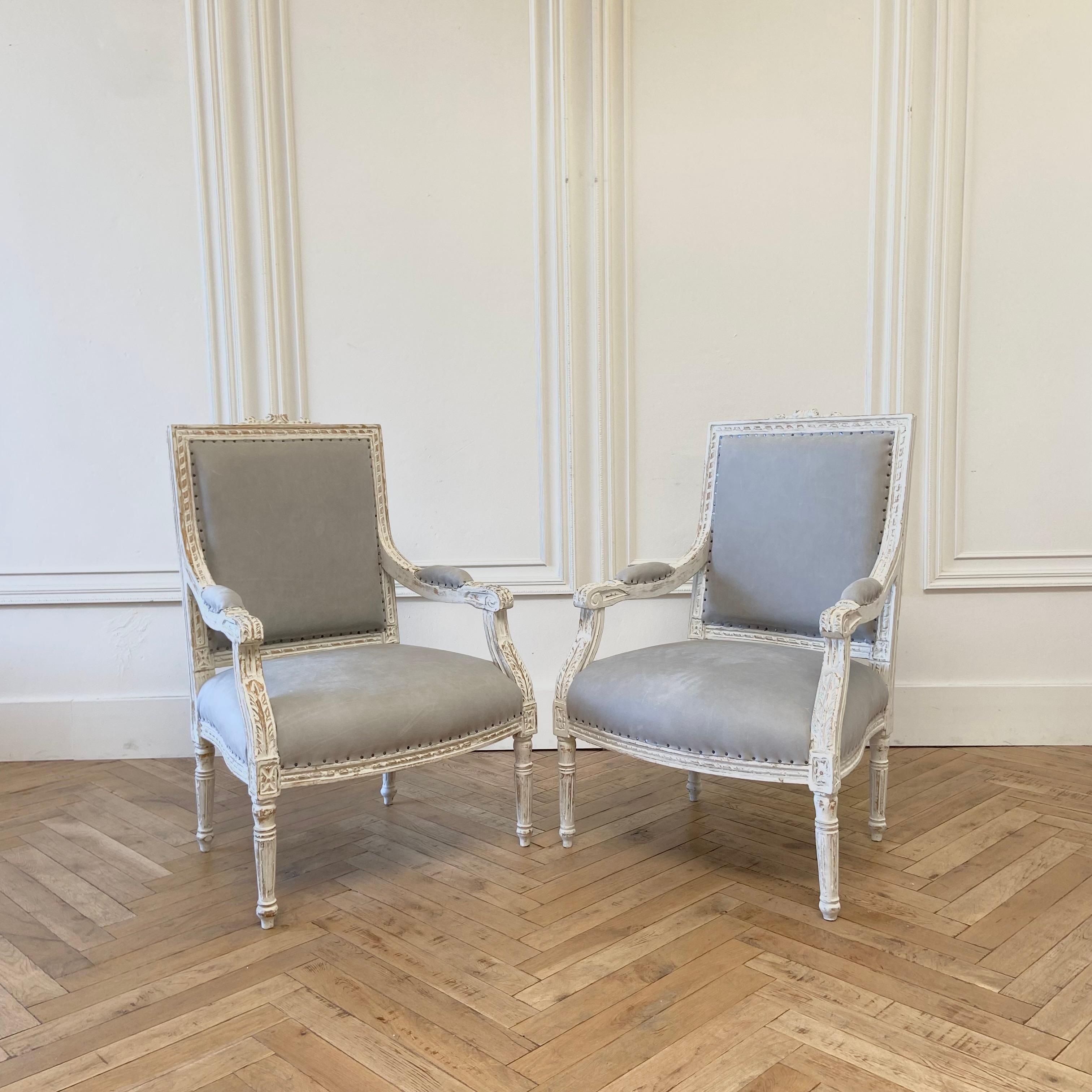 Vintage pair of leather chairs
Louis XVI style
Painted in an antique white finish with subtle gray tones.
Reupholstered in a soft ocean Gray sueded leather, and finished with antique nail head trim.
Solid and sturdy ready for everyday