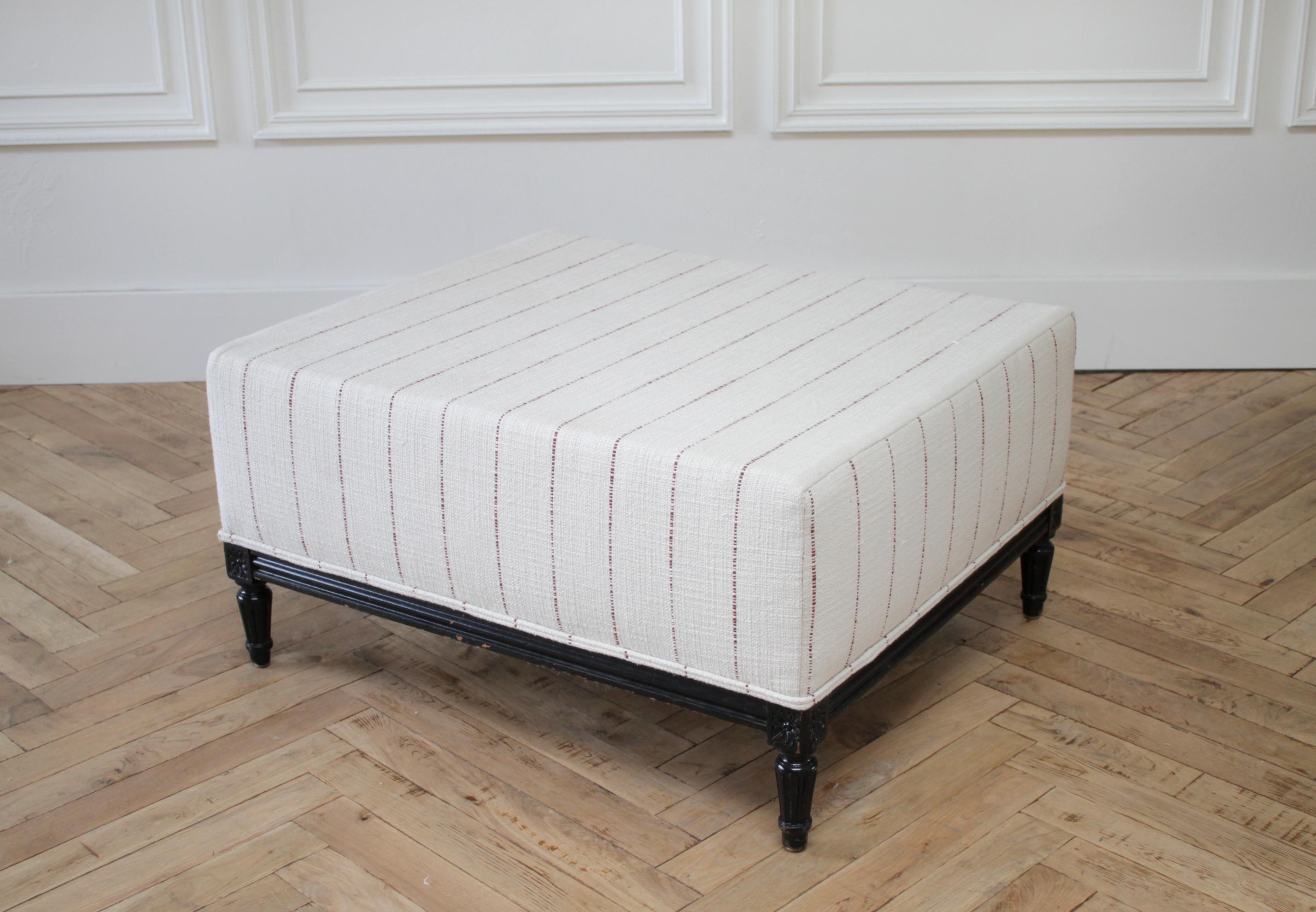 Vintage Louis XVI style upholstered bench cocktail ottoman
The frame is painted in a distressed ebony finish. We had upholstered in a thick nubby textured grain sack style fabric, that has a deep rust brown stripes. The background of the fabric is