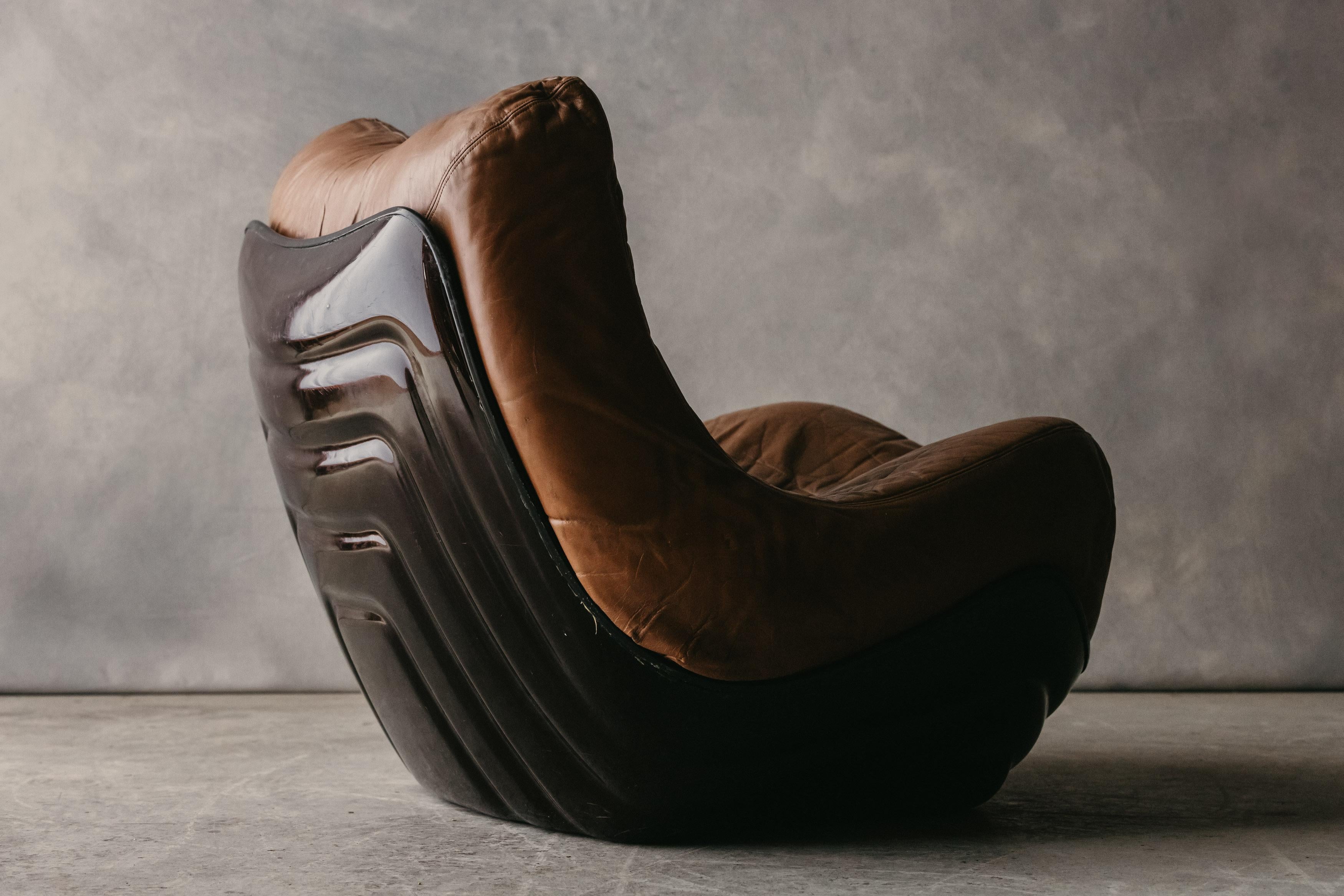 Vintage Lounge Chair By Bernard Gavin For Line Roset, Circa 1970.  Rare model with original brown leather and plastic shell frame.  Nice wear and use.

