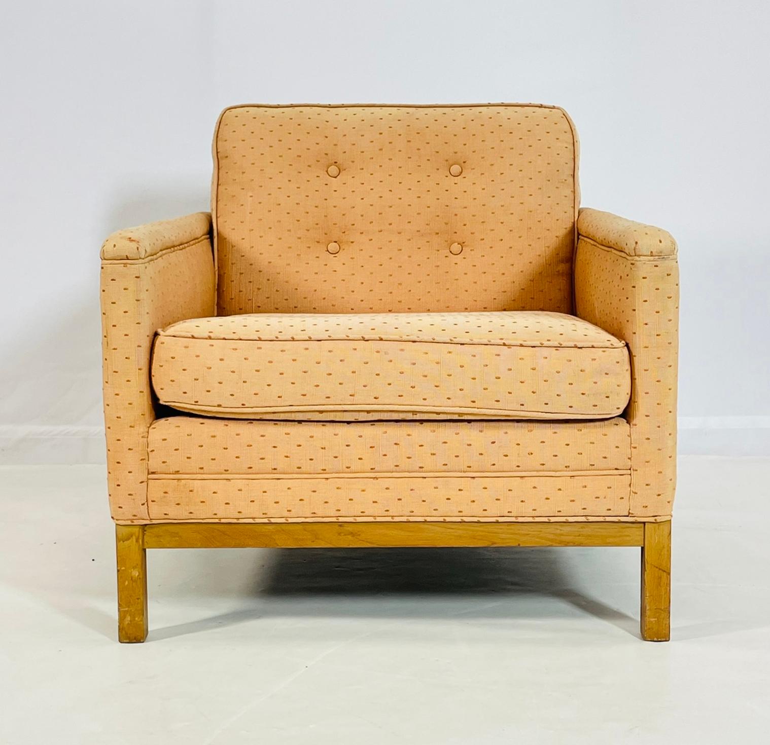 A classic Mid-Century Modern club chair by Phyllis Morris Originals, Los Angeles. This piece features a boxy silhouette with tailored button-tufted back cushion, loose seat cushion, and side panel detailing. Upholstered in its original peach-colored