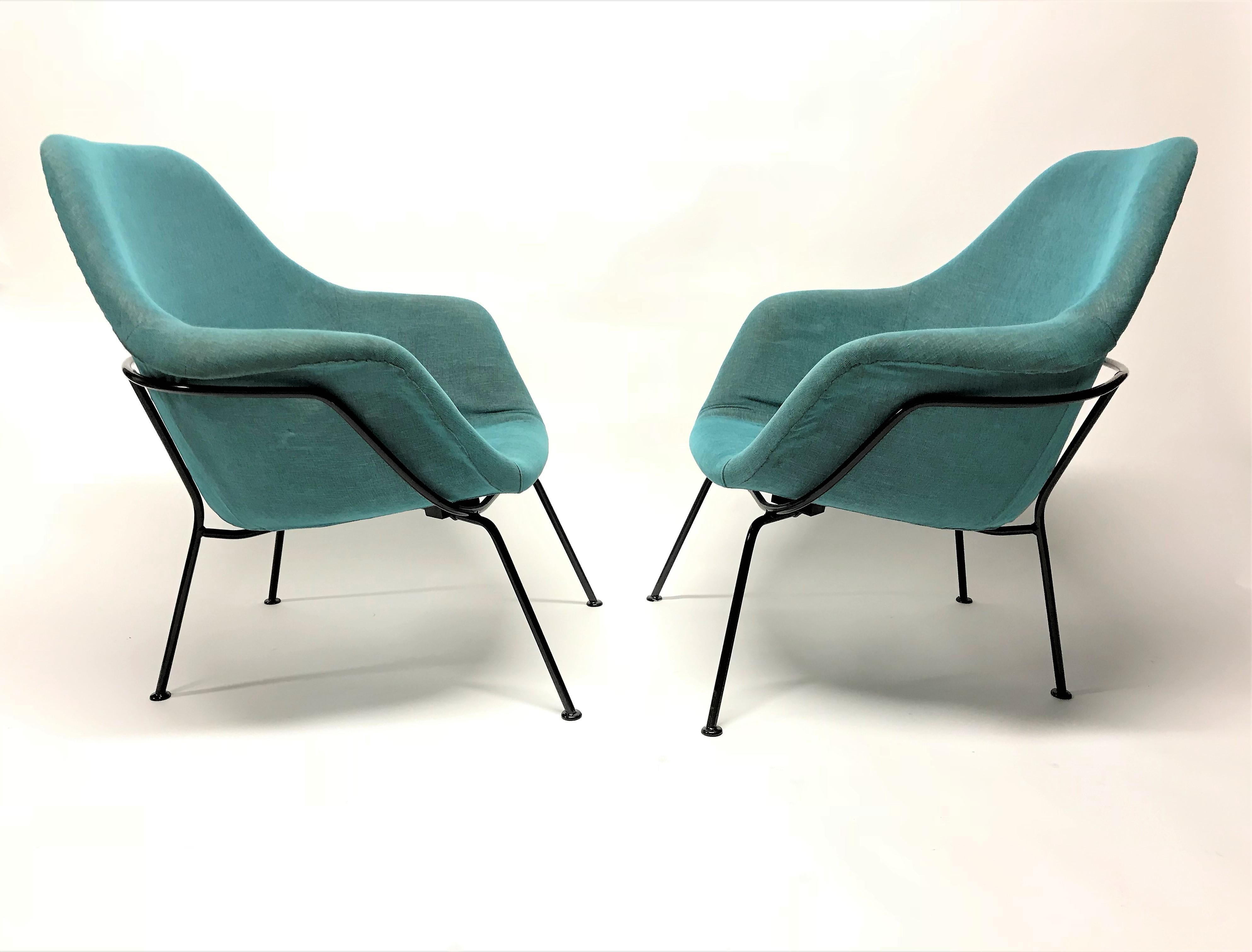 Pair of stunning midcentury bucket chairs designed by Miroslav Navratil.

The chairs consist of two shells upholstered with a modern turquoise fabric mounted on a lacquered metal frame.

The beautiful blue/turquoise color make the chairs a real