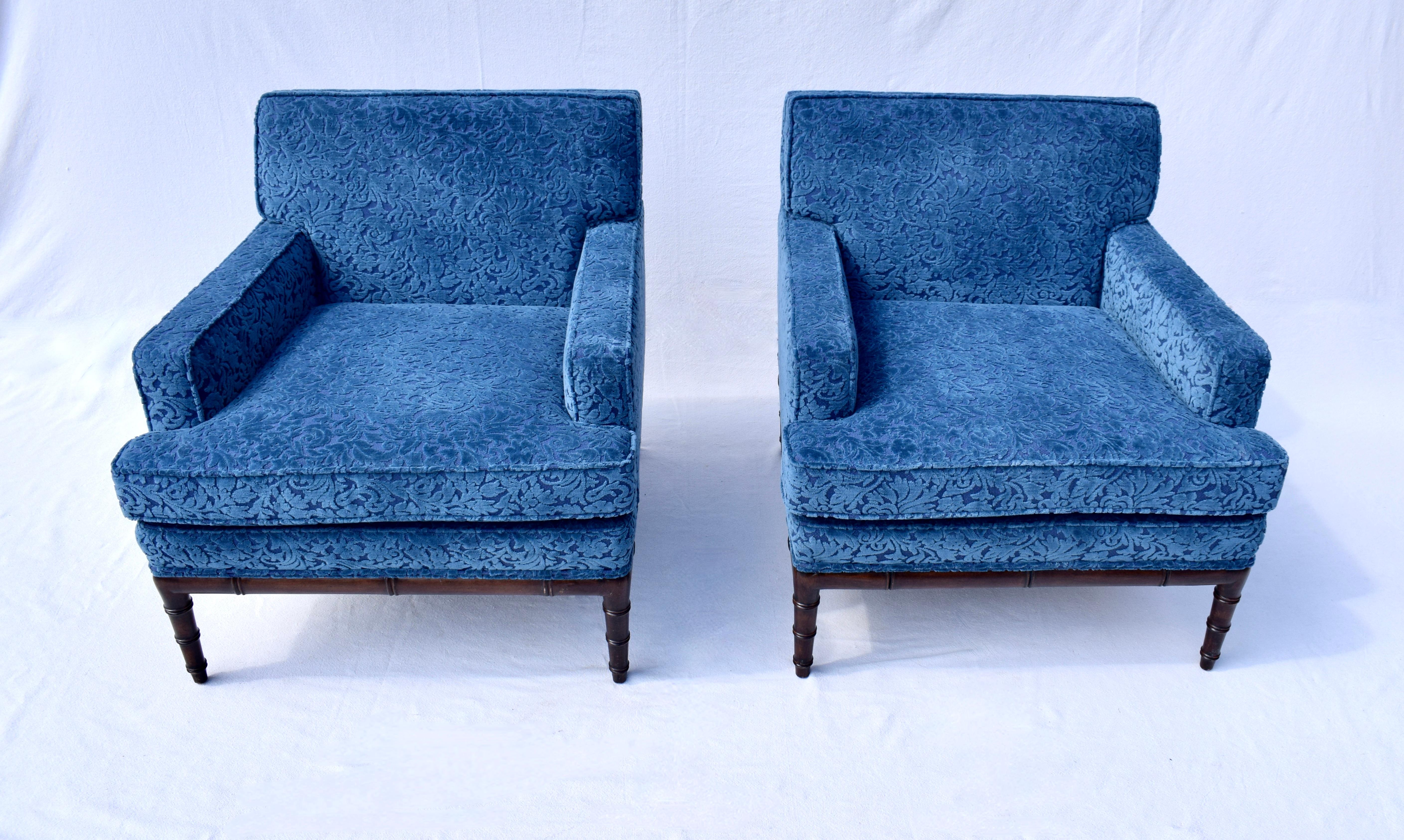 Vibrant Indigo blue cut velvet pair of 1960's club chairs with faux bamboo styling to each base attributed to Irwin Lambeth. These mid 20th Century beauties are fully restored & ready for use. Arm rest covers are included. Seats: 19.5