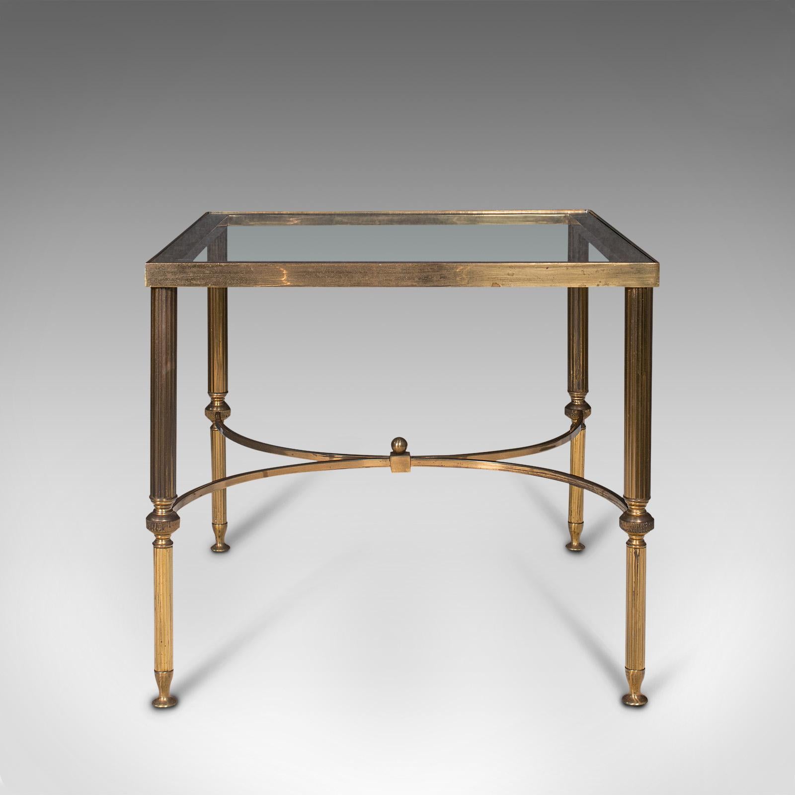 This is a vintage lounge coffee table. A French, brass and glass occasional table, dating to the late 20th century, circa 1970.

Striking tonality with overtones of Empire and Art Deco taste
Displays a desirable aged patina throughout
Polished