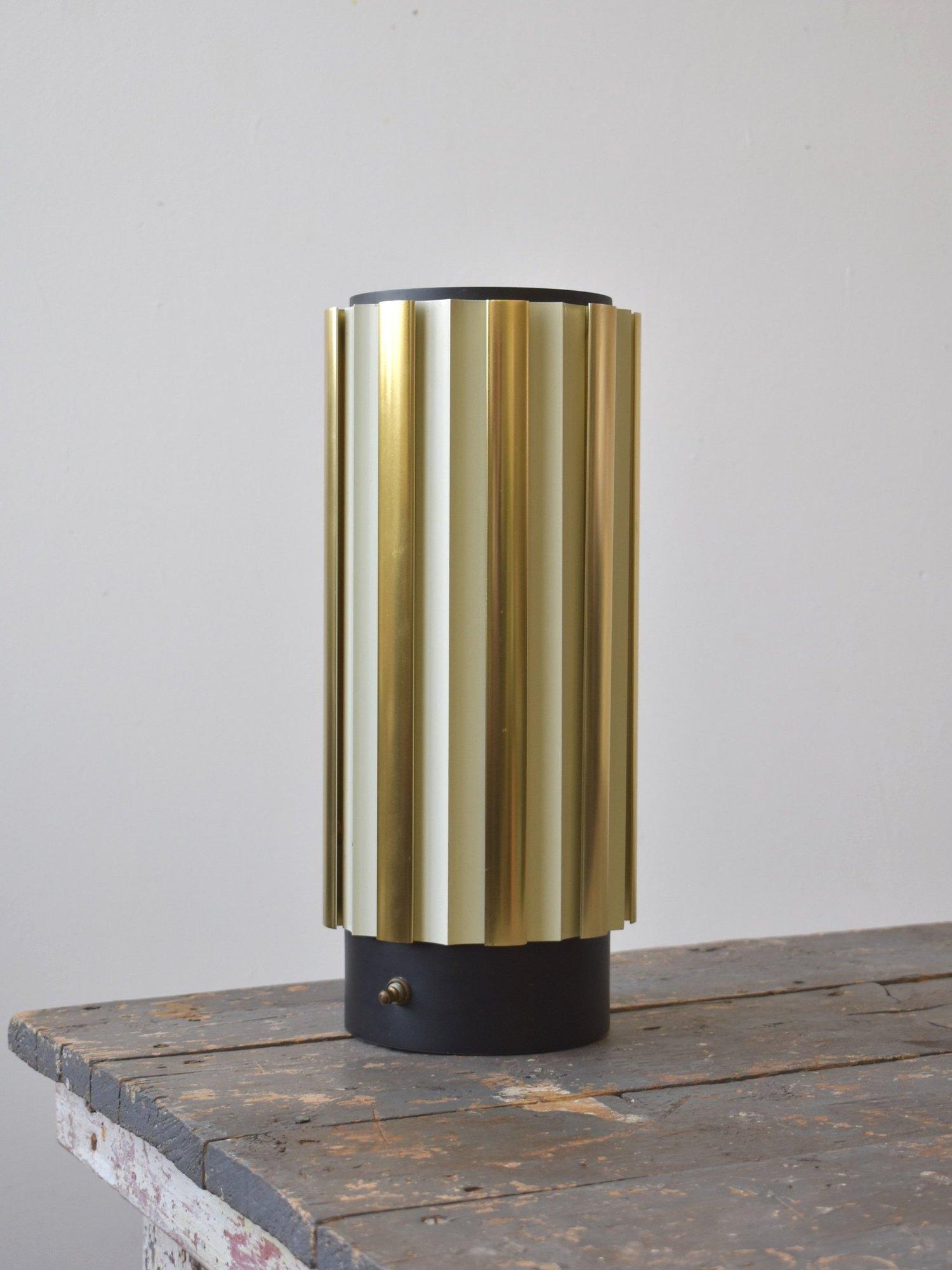 Vintage Louvered Metal Lantern Lamp Attributed to Gerald Thurston for Lightolier, Circa 1960s. Cylindrical body with louvered aluminum fins alternating between gold-tone and cream, allowing a unique pattern of warm light to emit from the lamp.