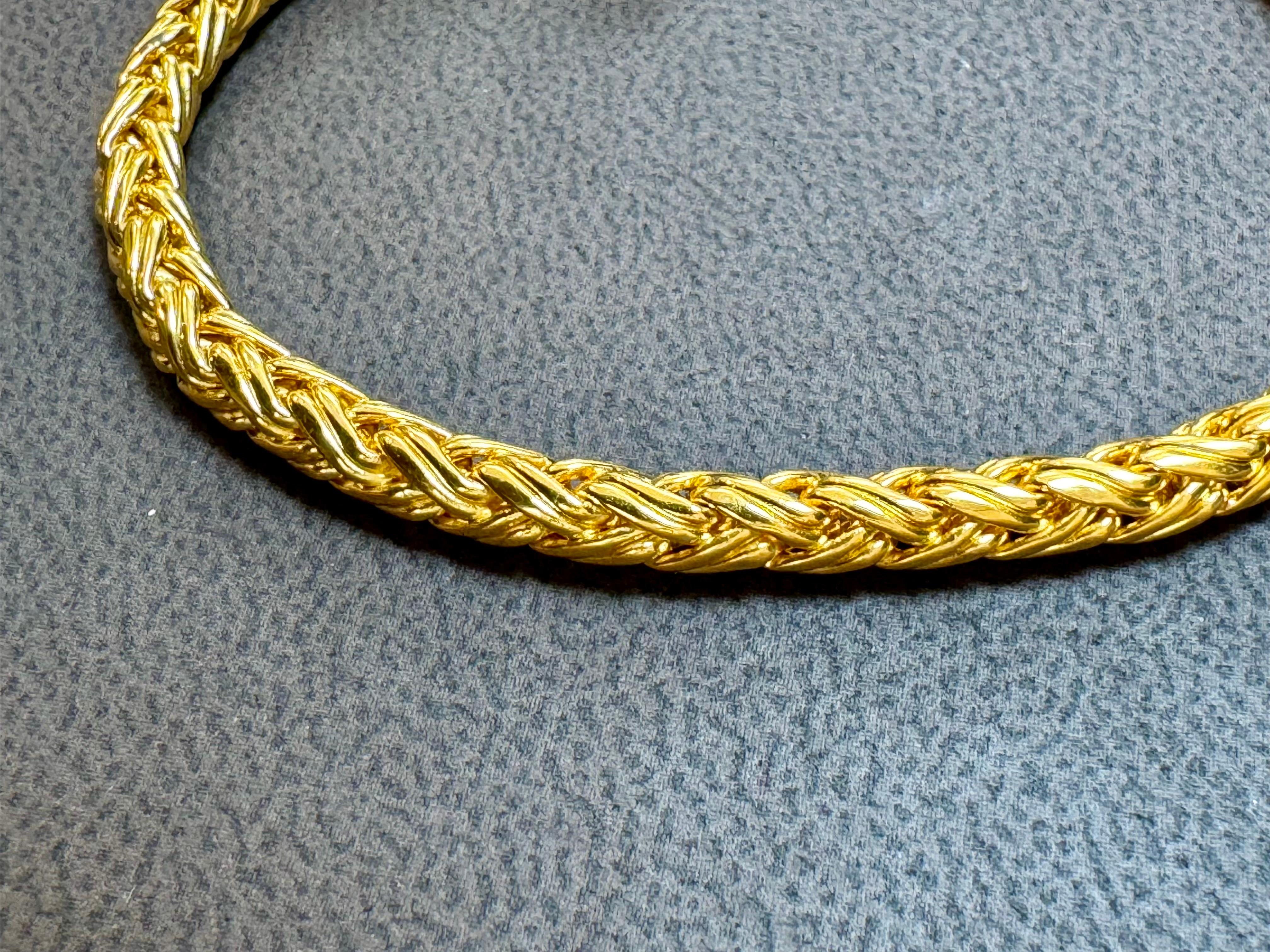 This magnificent bracelet is part of the Love Nest collection. Strands of 18kt yellow gold are woven to produce a thick bracelet , and two rondels of smooth 18kt yellow gold  This bracelet is a fabulous accent piece for any occasion.

Crafted from