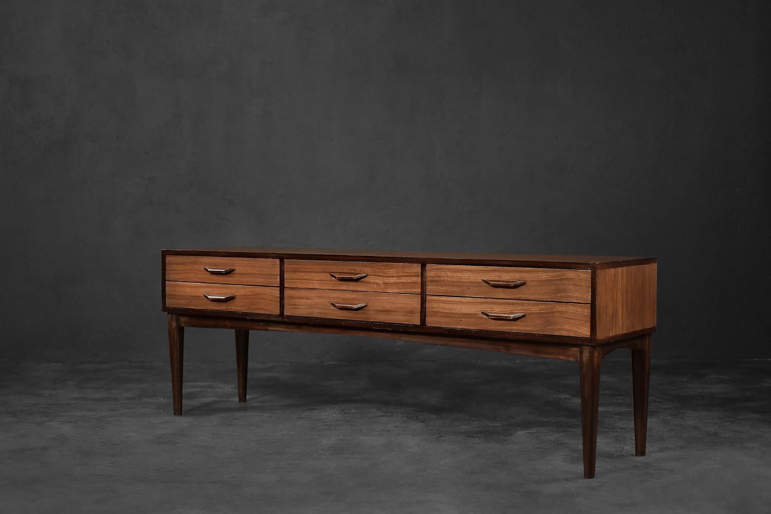This classic sideboard was made in Denmark during the 1970s. It is made of an extremely interesting and rare wood, which is mahogany okoume from Equatorial Africa, which is characterized by a slightly pink shade of brown. Due to its exceptional