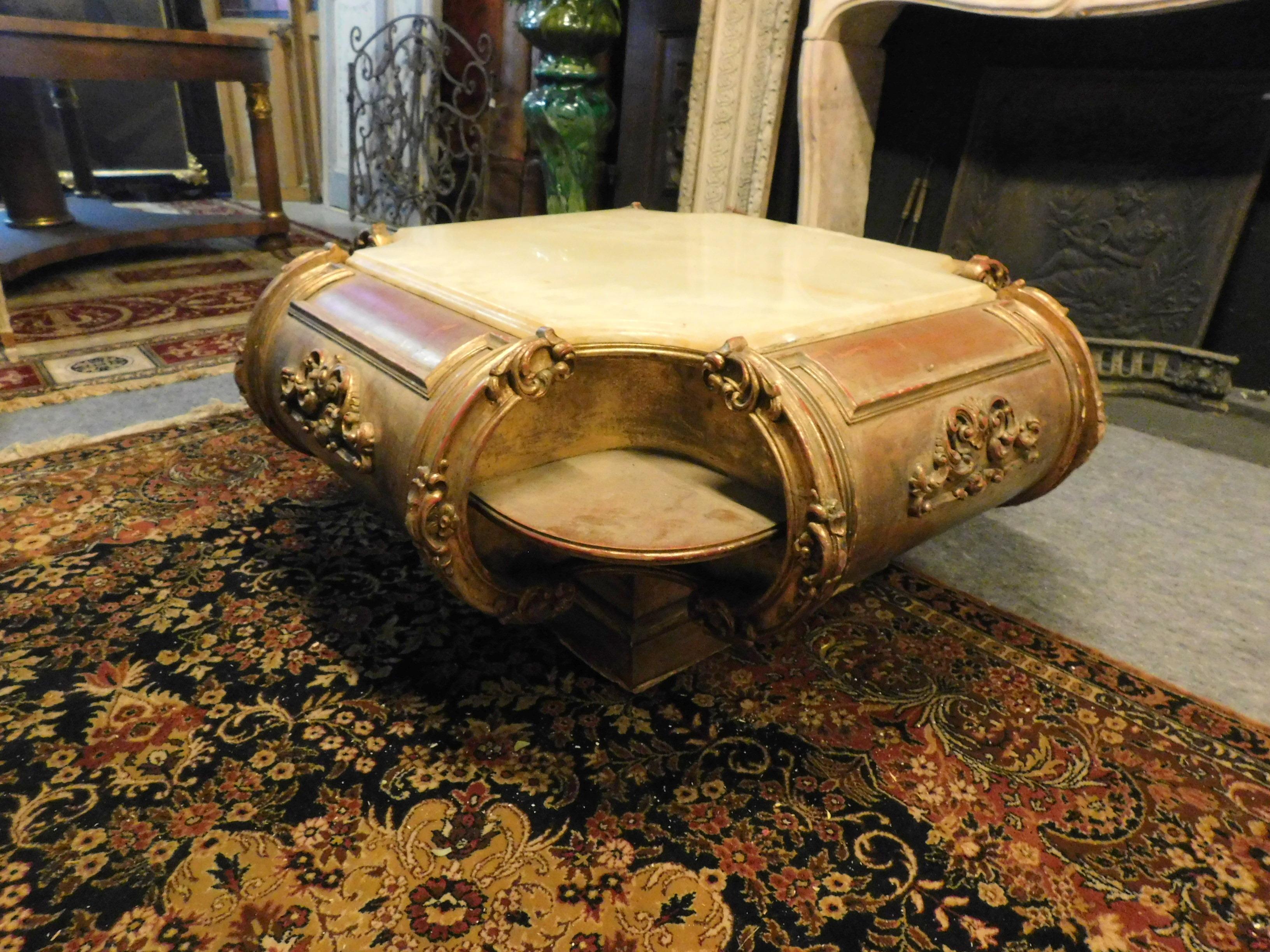 Vintage low table, ideal for the living room or next to a sofa, antique gilded and sculpted on the rounded sides, with yellow marble top, built at the beginning of the 20th century in Italy.
