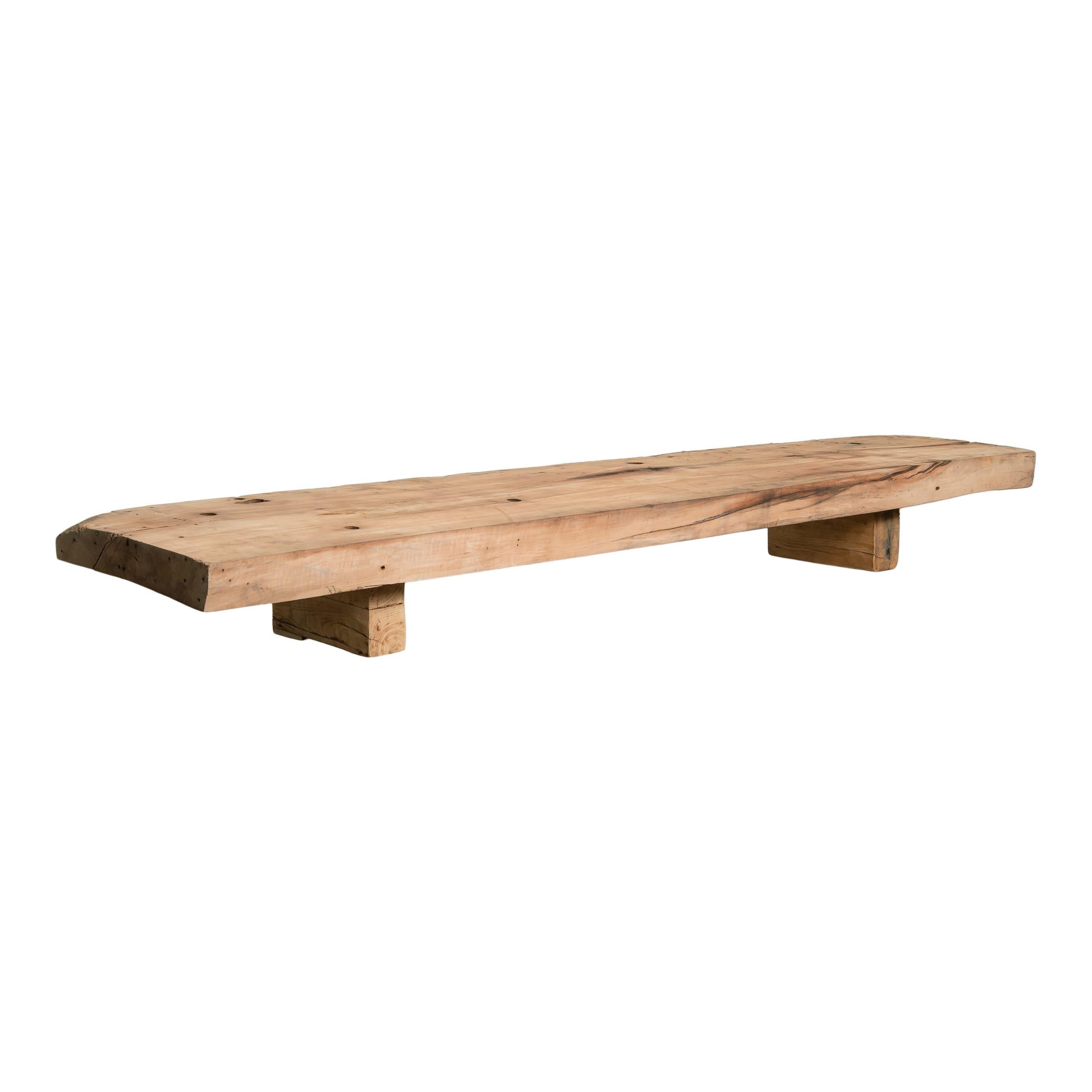 A beautiful vintage wood low coffee table or tabletop riser. This piece is simple and classic, featuring amazing wood grain details and vintage patina from years of use. The top is a long a skinny rectangle and the legs are just as simple and