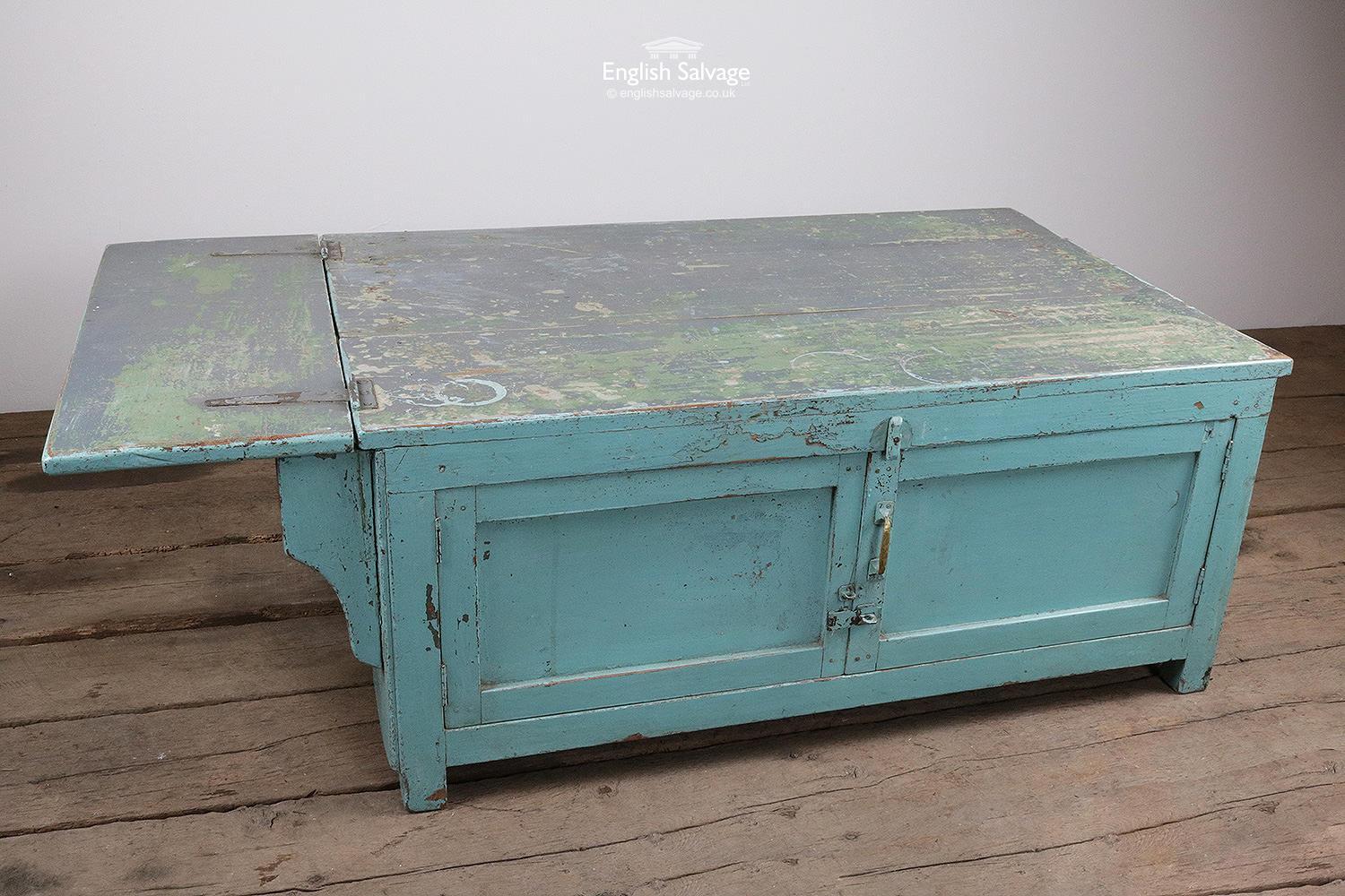 Reclaimed vintage low height storage unit / coffee table with double doors and a distressed light blue / green painted finish. The width below doesn't include the leaf which folds out approximately a further 43cm. Scuffs to paint finish and dings,