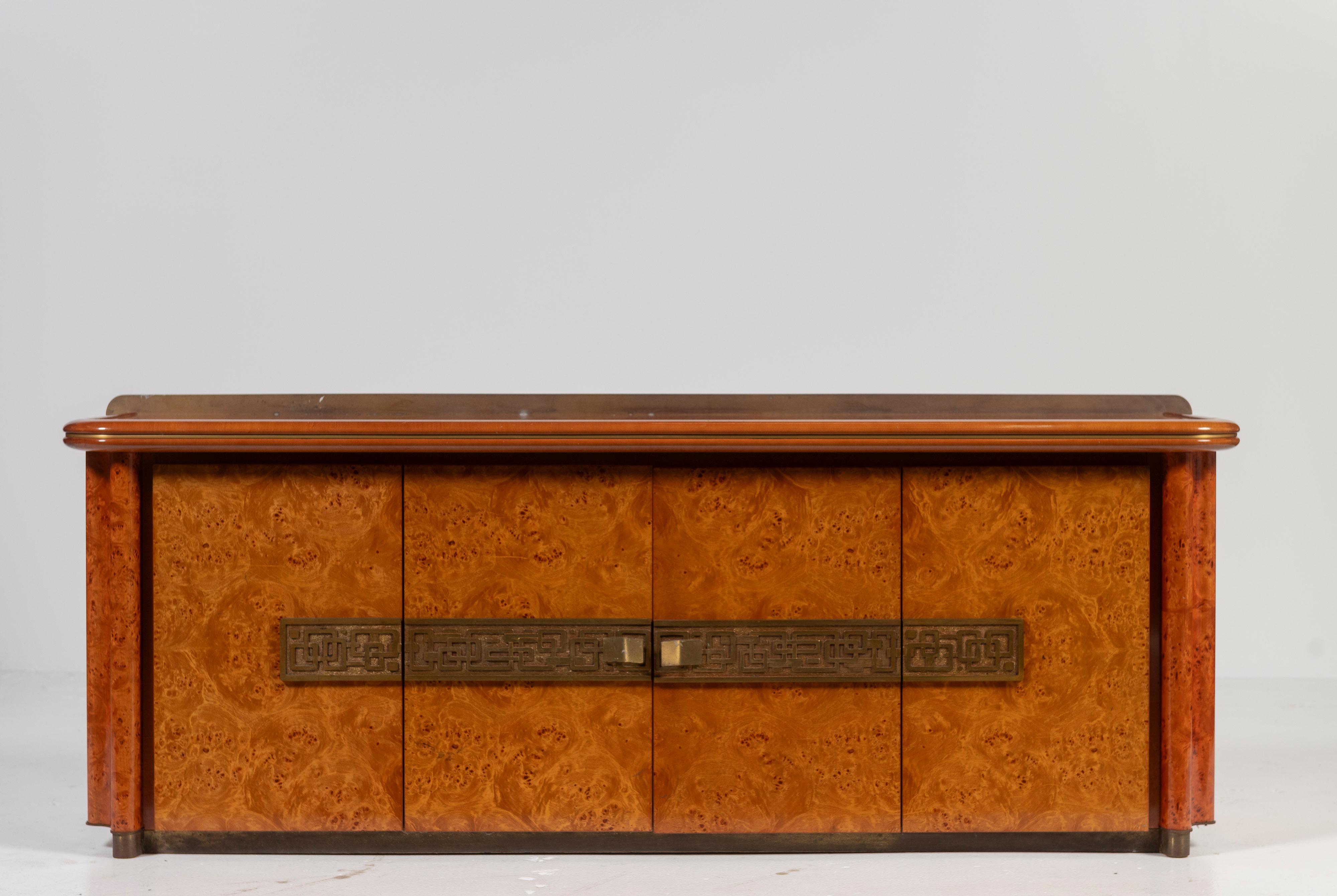 Solid burl, brass and bronze vintage cabinet, by Italian Luciano Frigerio, can serve as a cabinet, buffet, dresser or sideboard. Beautifully designed with curved edges and intricate metal accents, the doors open to reveal the four drawers and two