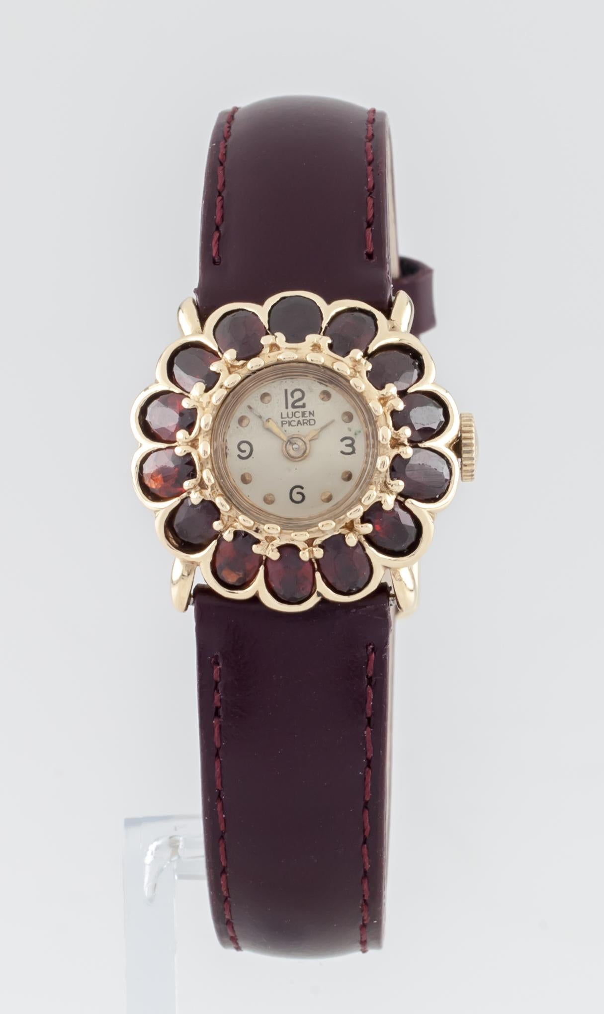 Movement #A5976
Serial #43591
Case #A03077
14k Yellow Gold Case w/ Garnet Flower Bezel
24 mm in diameter including garnet petals
Lug-to-Lug Length = 21 mm 
Lug-to-Lug Width = 16 mm
Thickness = 9 mm
Champagne Colored Dial w/ Gold Hands
Labeled