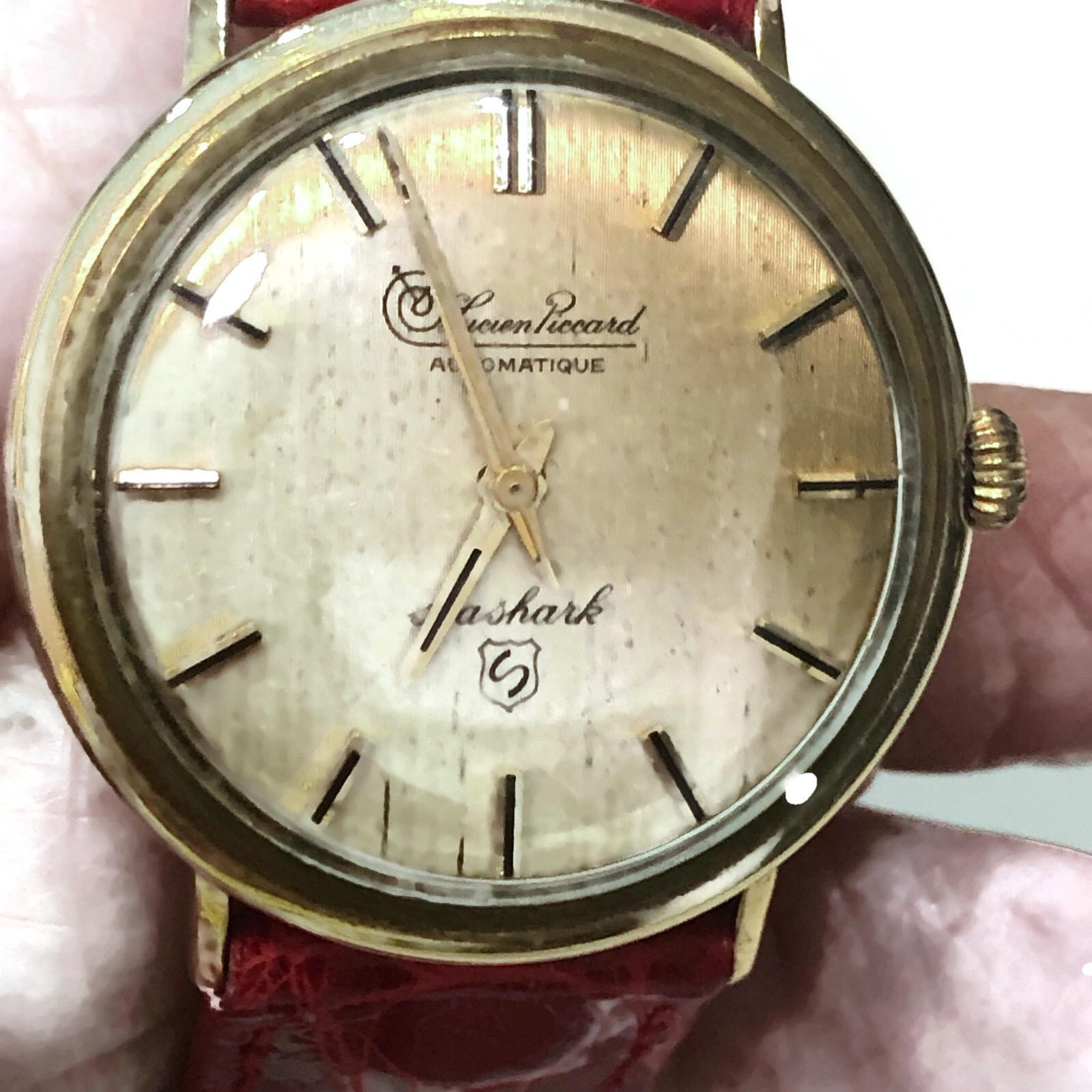 Vintage Lucien Piccard automatic movement 14k yellow gold  watch with a round face and a red crocodile band.  The watch is in a classic style.

The watch is in mint condition  Although it is a Vintage watch, it is totally in style today.

A