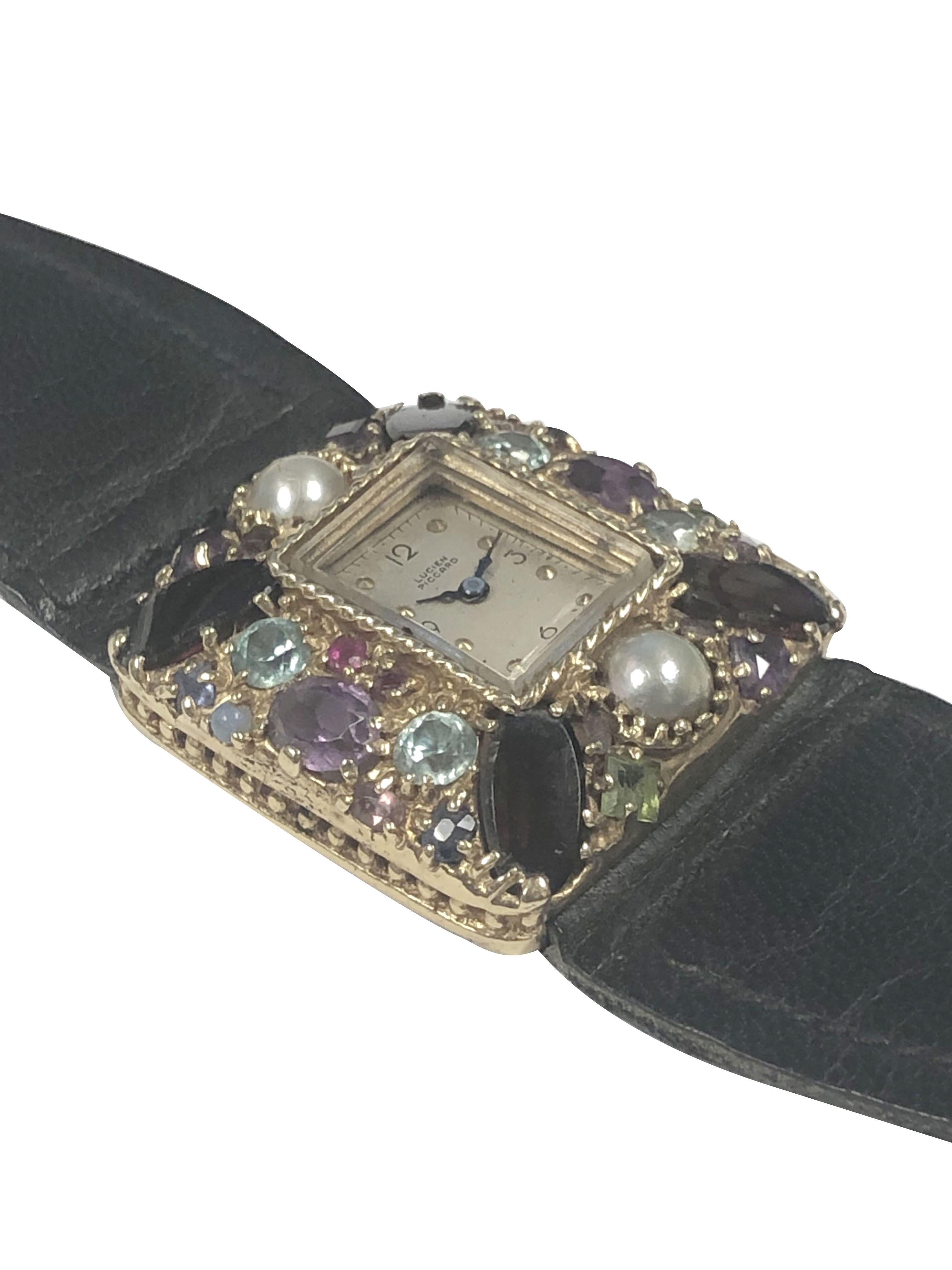 Circa 1960 Lucien Piccard Ladies Tutti Frutti Wrist Watch, 30 X 31 X 8 M.M. 14K Yellow Gold case that is set with Pearls, Garnets, Amethyst, zircon, Peridot. 17 Jewel mechanical, manual wind movement, silver satin dial  with raised gold dot markers.
