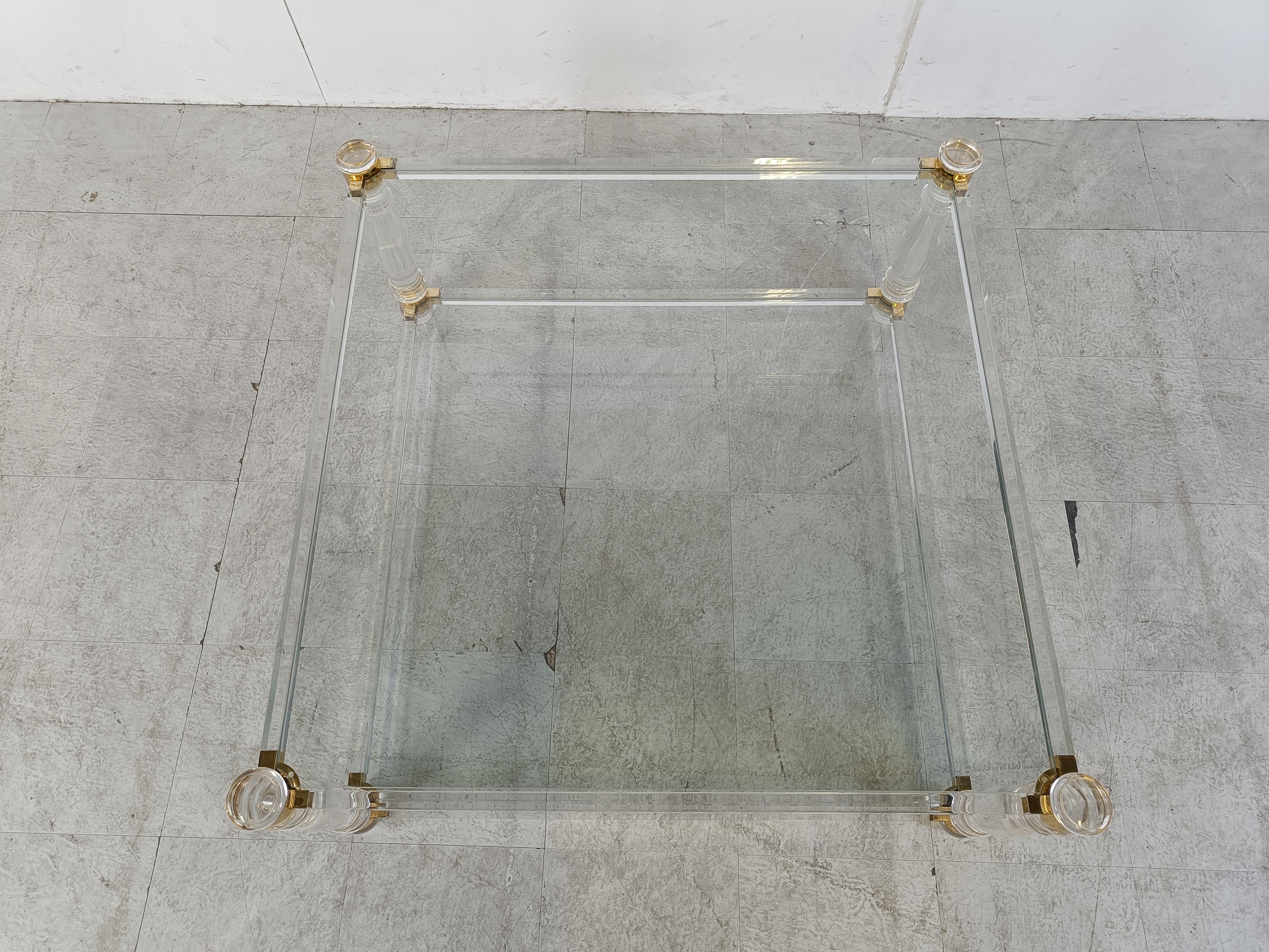 Vintage coffee table with a lucite frame, brass corners and glass plates.

Good condition.

Very modern looking and decorative table that can be combined with lots of interior styles.

Good condition.

1970s - Belgium

Dimensions:
Height: