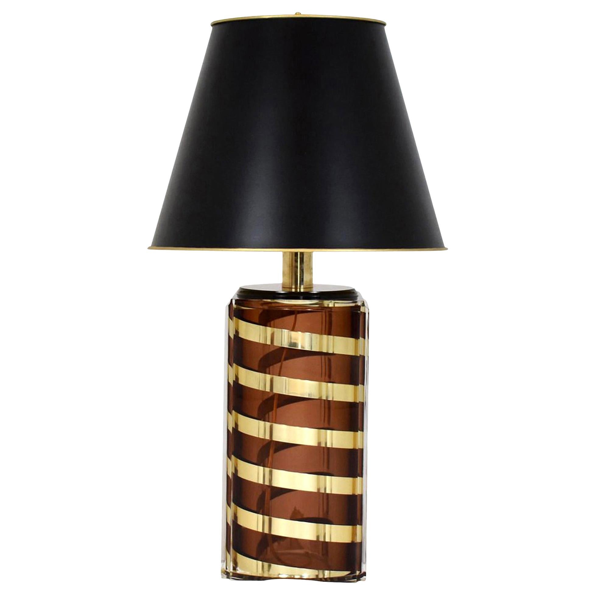 A vintage Lucite and spiraling brass table lamp with gold lined black paper shade newly wired. Lamp base is whiskey in coloring.