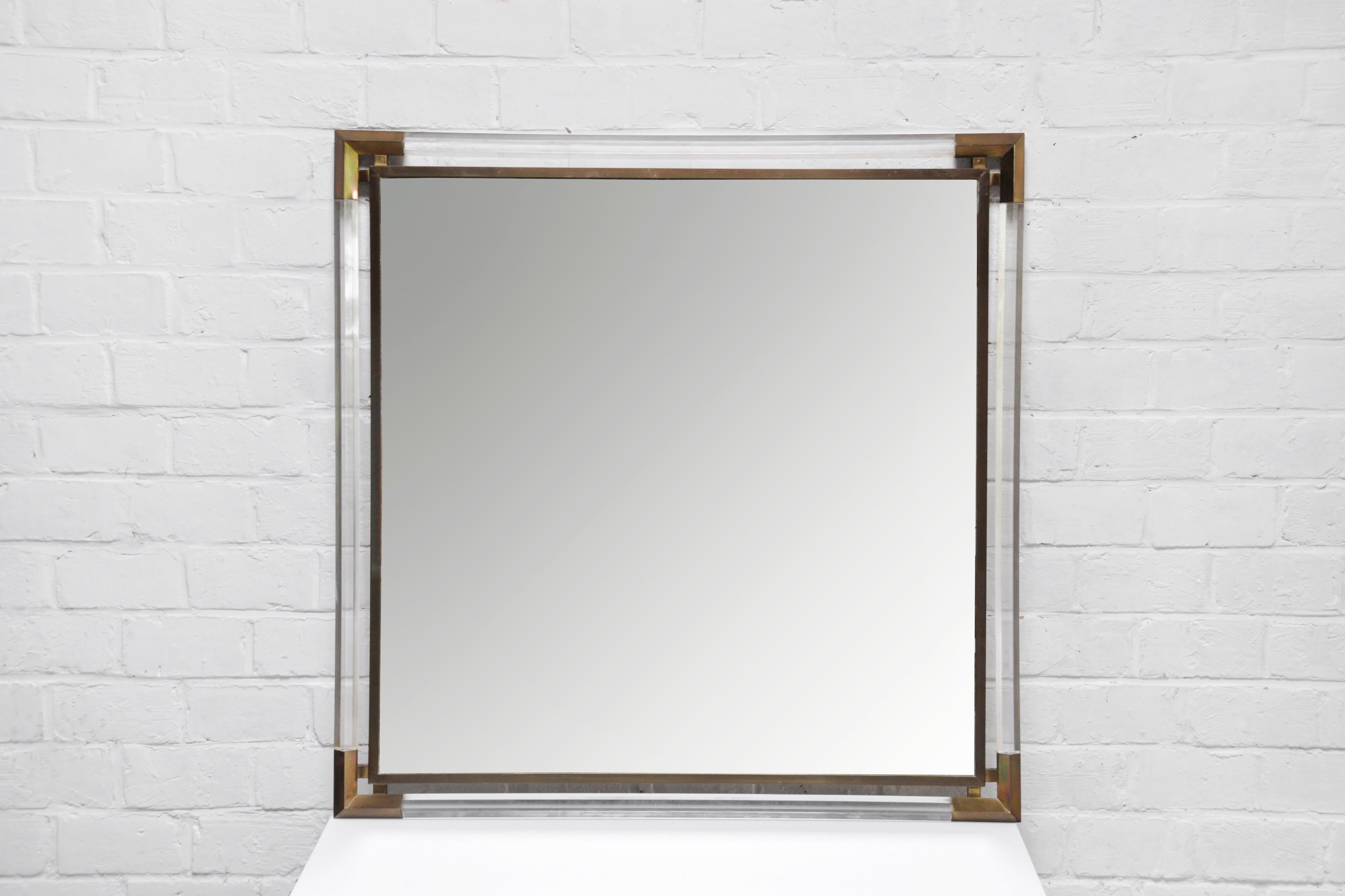 A stunning large square mirror with structure in lucite and gilded brass. Circa 1970, presumably made in France. The designer is unknown to us but the style is reminiscent of Maison Janssen, Pierre Vandel and Charles Hollis Jones. In good condition,