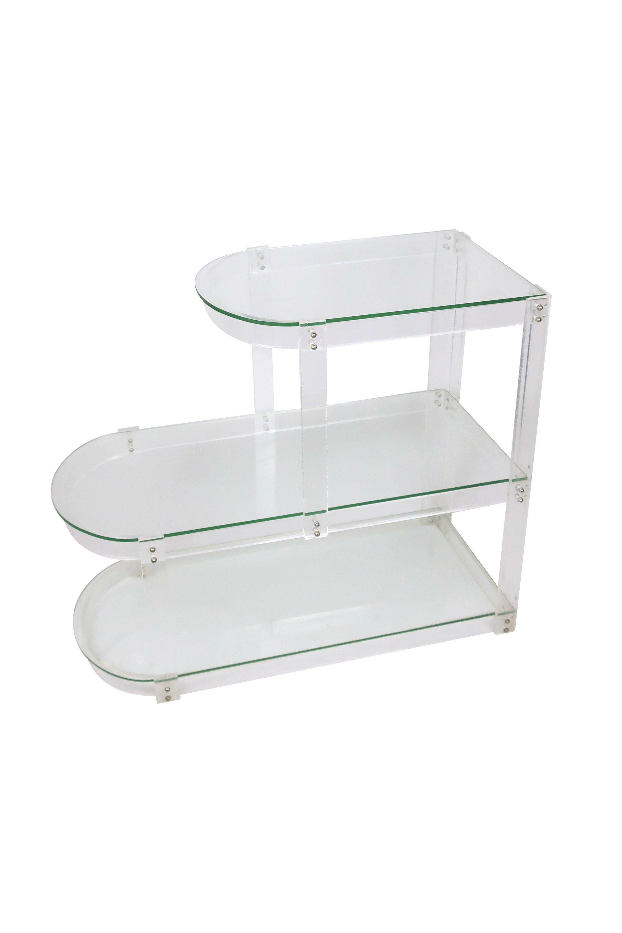 A Mid-Century Modern Lucite and glass shelving unit that is small enough to be used as a side table, bookshelf, bar, or even a console table. In the style of Charles Hollis Jones.
 
In excellent vintage condition. Unsigned.
 
Measures: 13” x 29”