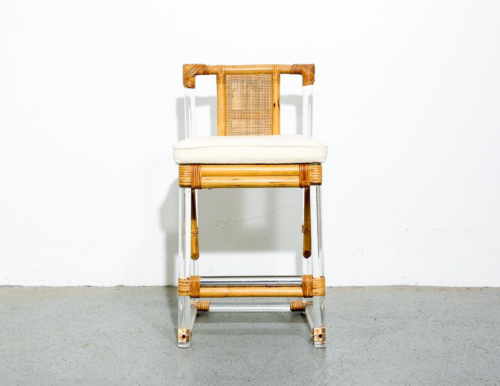 Vintage counter stool in lucite and rattan with wool ivory boucle upholstery. Measure: 23