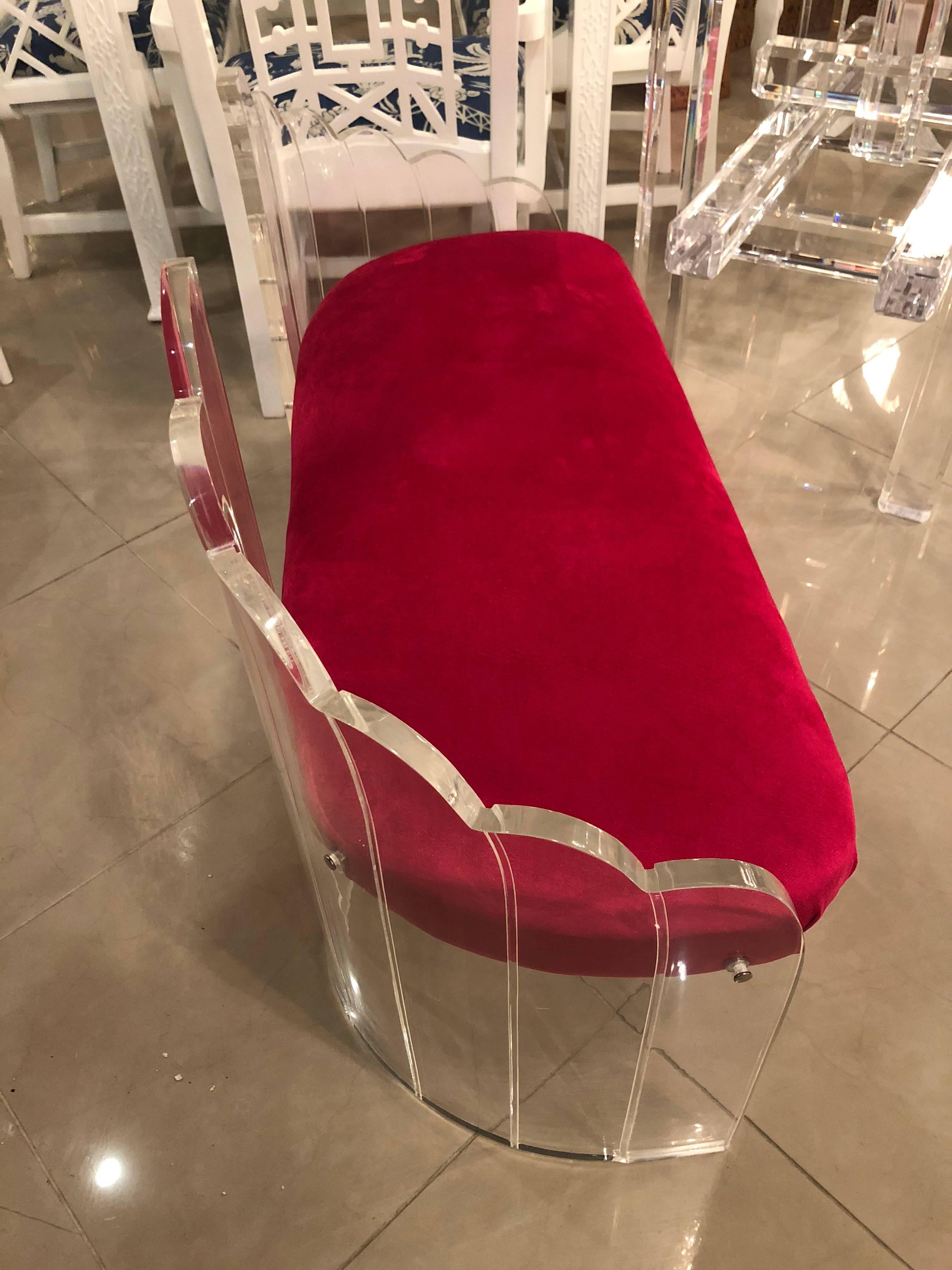Vintage Lucite bench that has been meticulously restored. The Lucite has been professionally polished. Newly upholstered in a hot pink velvet.