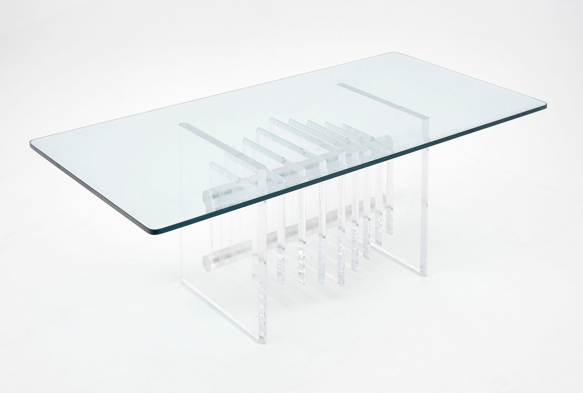 Coffee table made of clear Lucite with a glass top.