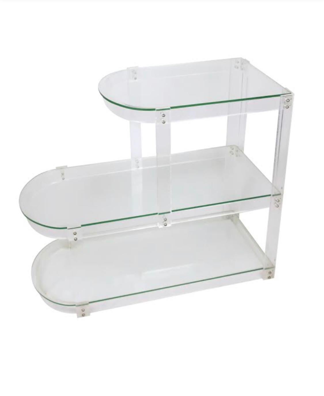 A Mid-Century Modern Lucite and glass shelving unit that is small enough to be used as a side table, bookshelf, bar, or even a console table. In the style of Charles Hollis Jones.

In excellent vintage condition. Unsigned.

Measures: 13” x 29” x