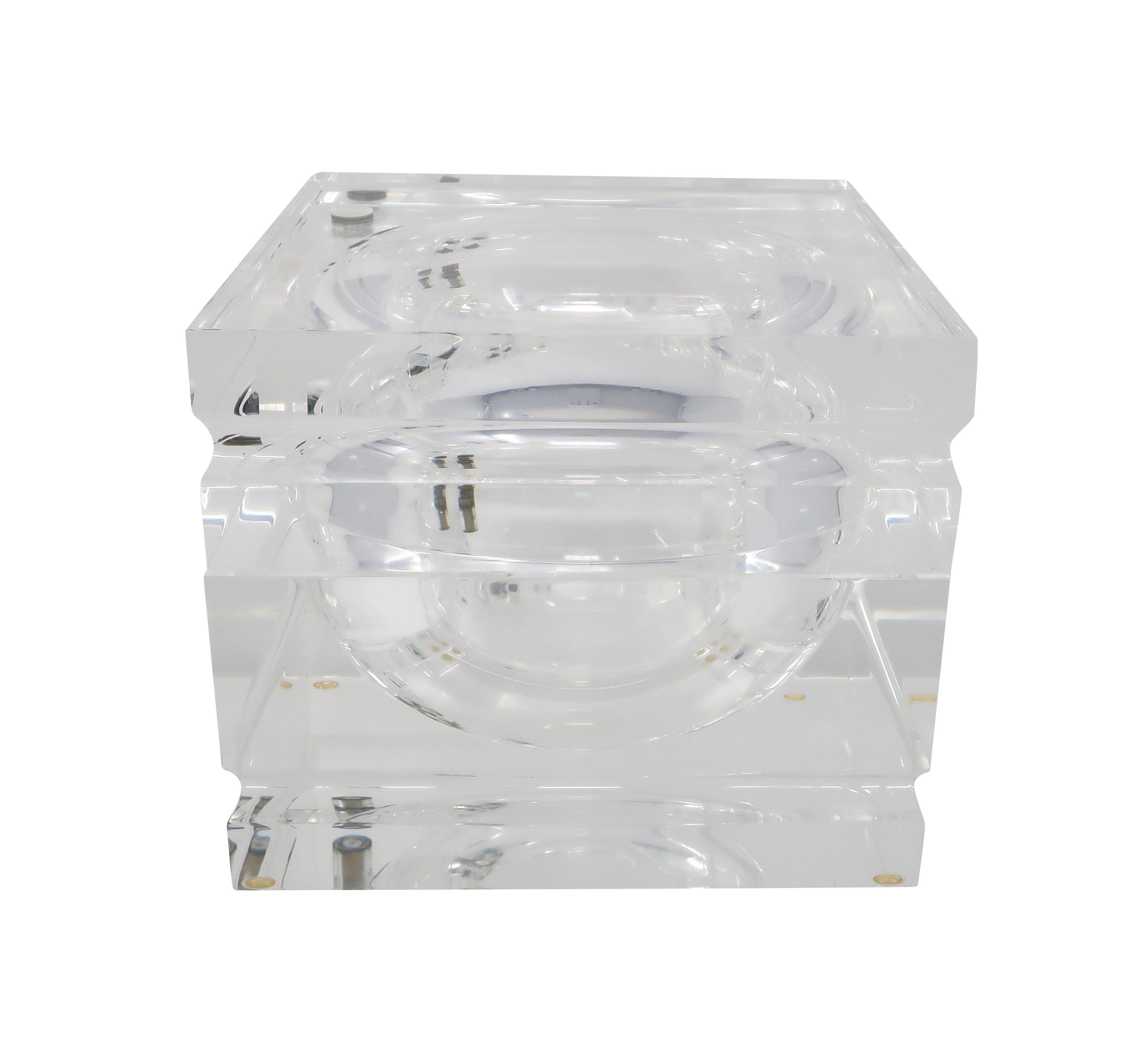 A stunning 1970s Lucite ice bucket attributed to Alessandro Albrizzi. The lid swivels on a pin to expose the ice storage within. Faceted edges that catch light beautifully. 

In excellent vintage condition. Unmarked.

Measures: 6.75” x 6.75” x