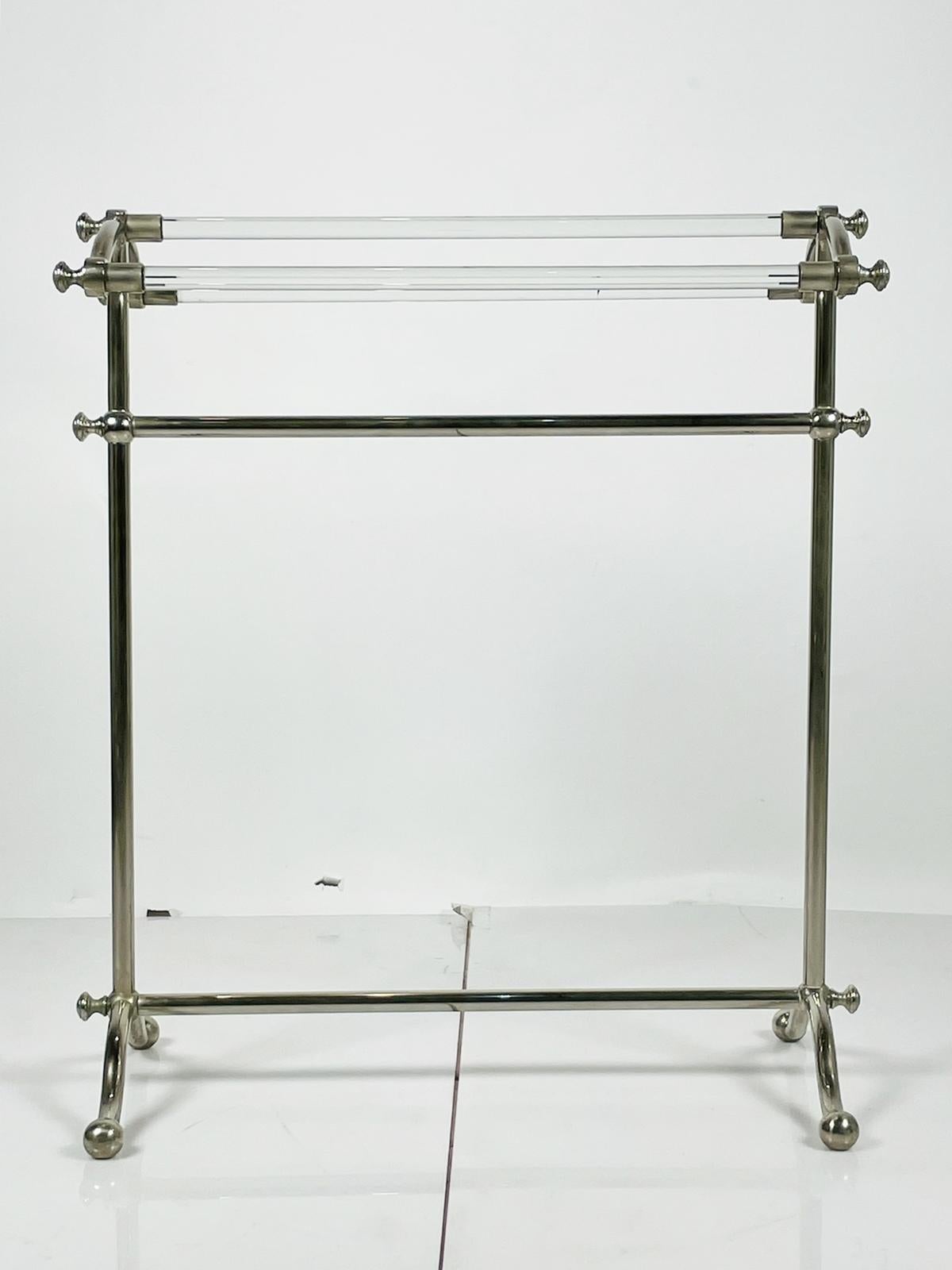 Vintage freestanding towel holder executed un lucite and nickel.

The piece has three lucite rods attached to the nickel frame, perfect for bathroom towels or in the bedroom to setup your clothes.

Measurements:
31.75 inches high x 28.25 inches wide