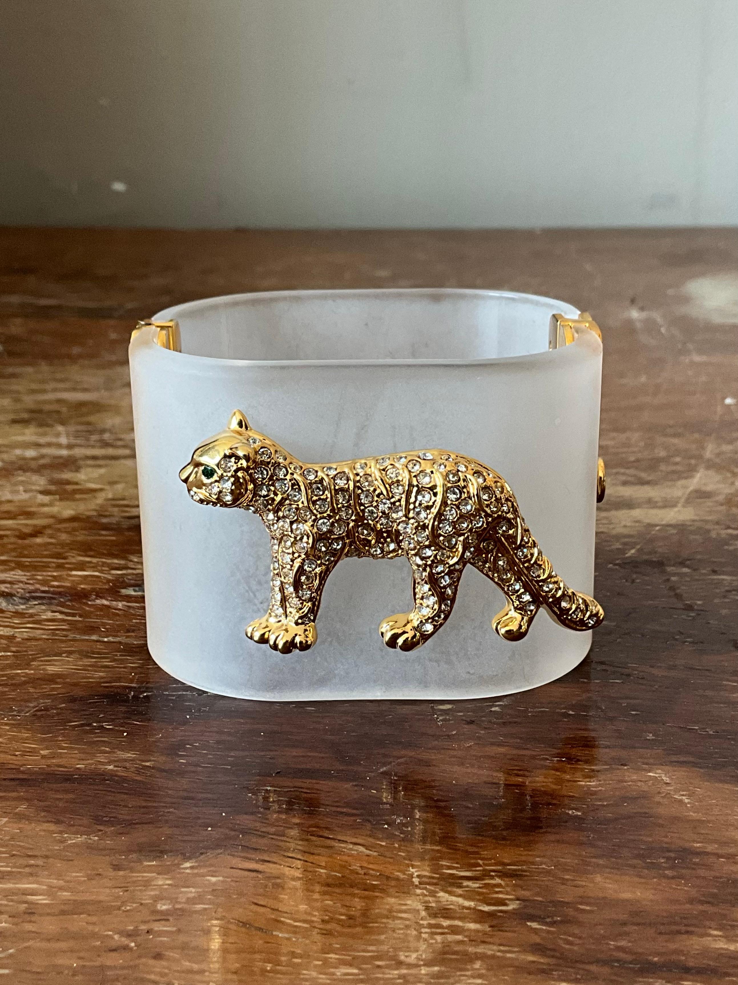 Channel bold vintage glamour with this stunning Lucite rhinestone leopard bracelet. Expertly crafted, this hinged statement piece features a sleek leopard design, its body formed from smooth, high-quality Lucite for a lightweight yet durable feel.