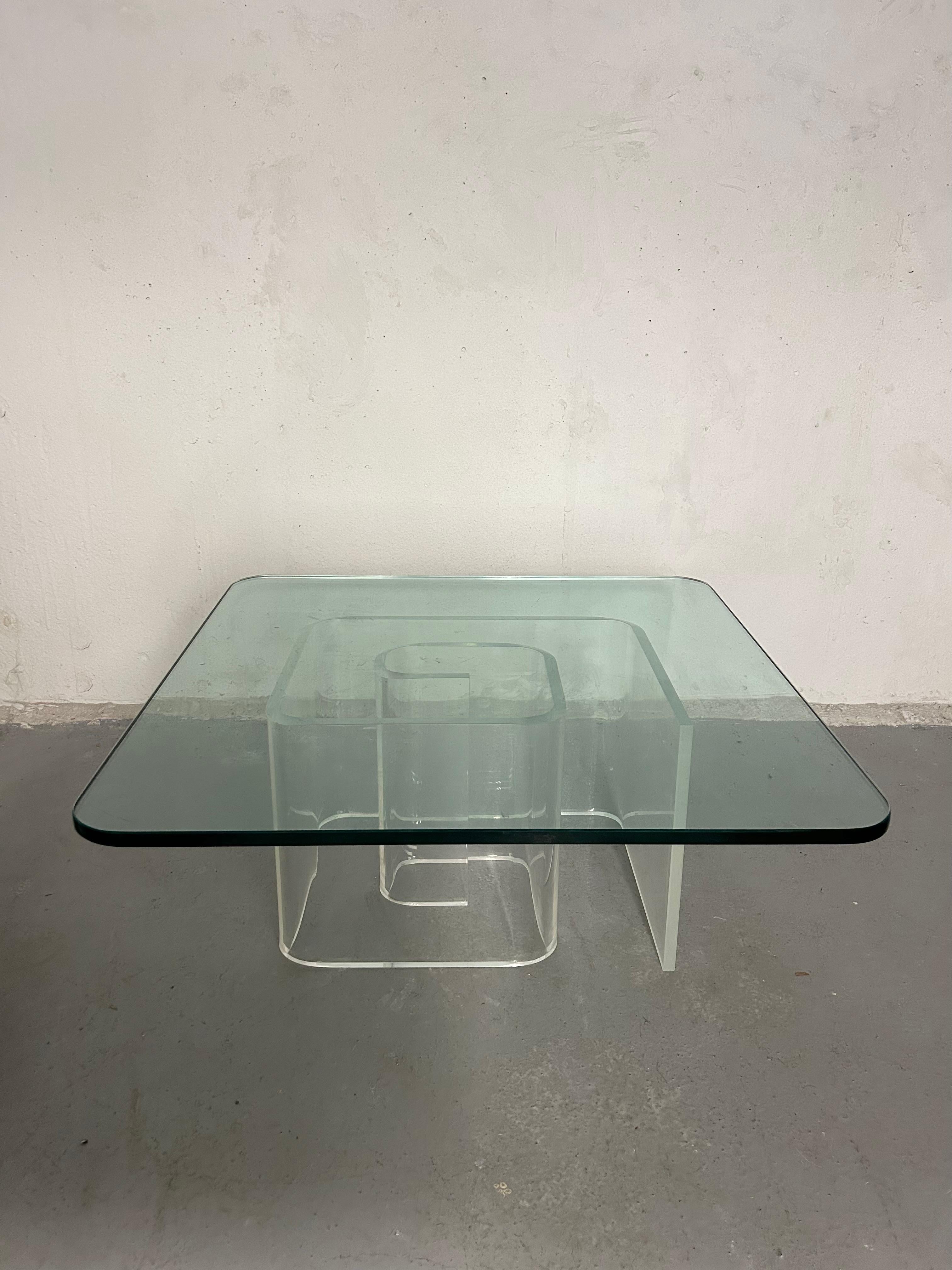 Vintage lucite and glass coffee table. Lucite base is a thick snail shaped sculptural design. 3/4” square glass sits separately on top. Lucite base has a little crystal using most likely due to the sun but it’s hard to see once the glass is sitting