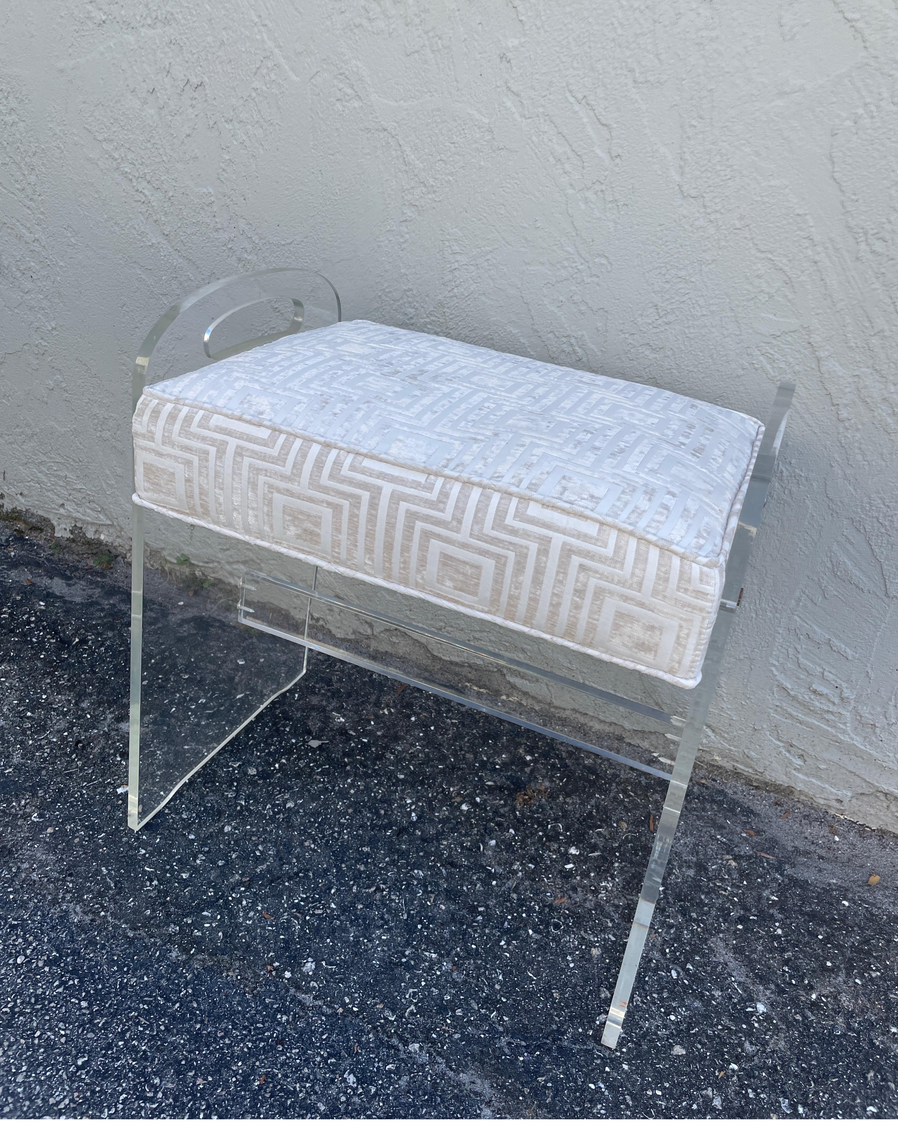 Vintage Lucite stool with newly upholstered seat cushion by Charles Hollis Jones.
A very classic design. Great vanity stool.