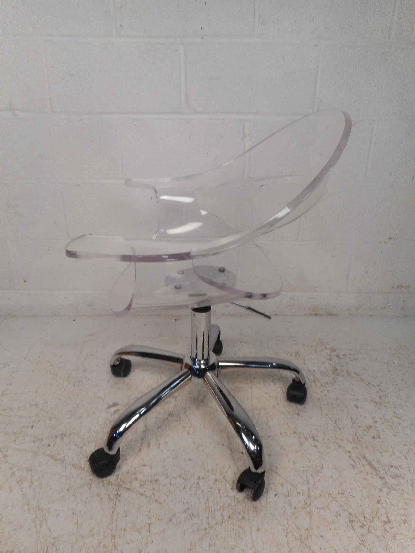 Great Lucite office chair on casters and a swivelling base. Sturdily constructed. The Lucite remains clear and transparent. Nice addition to any home or office. Please confirm item location with dealer (NJ or NY).