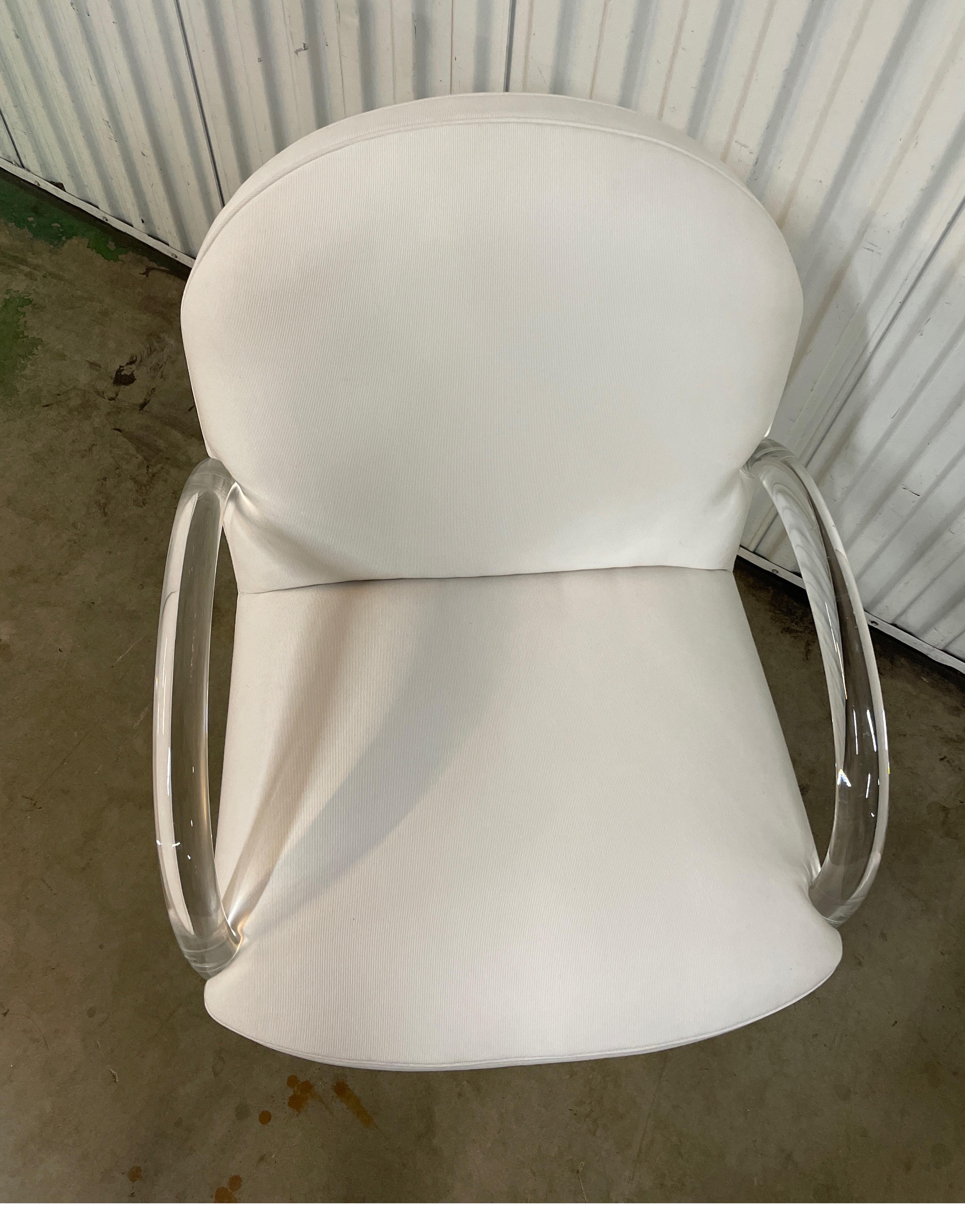 Waterfall lucite club chair with newly upholstered white fabric.